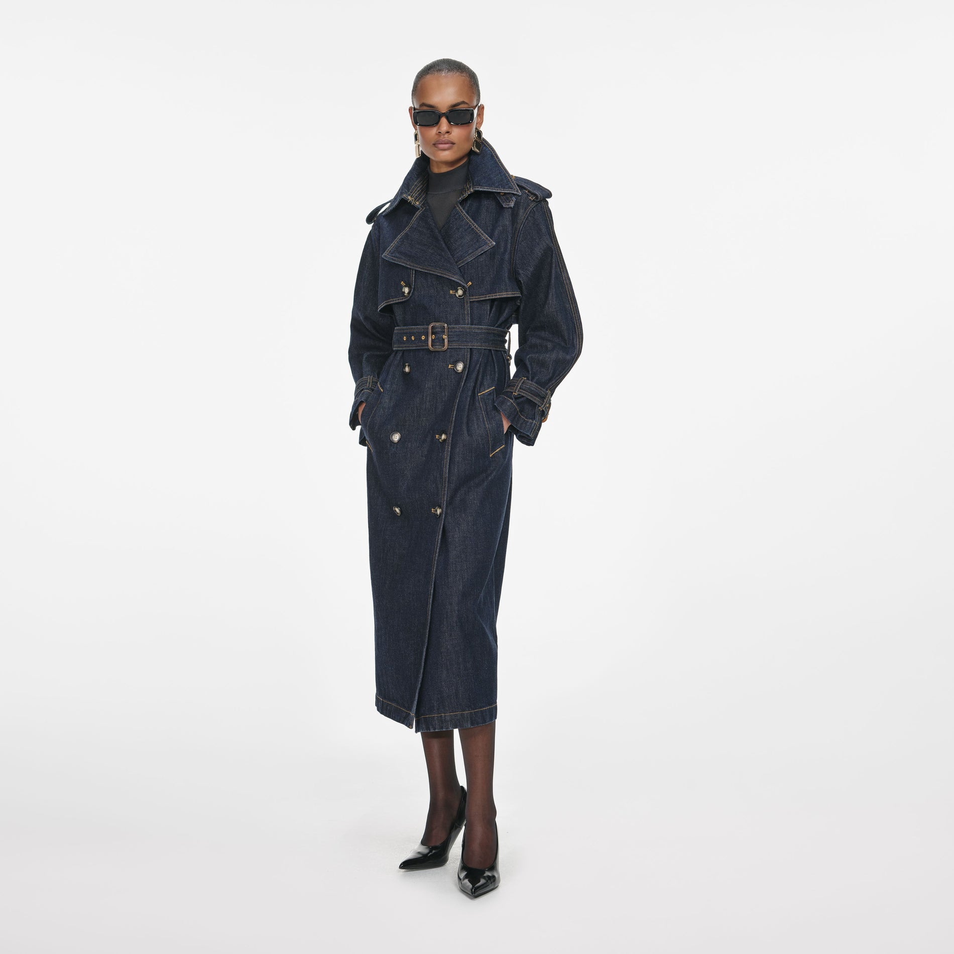 Side view of a woman wearing the Indigo Denim Trench Coat