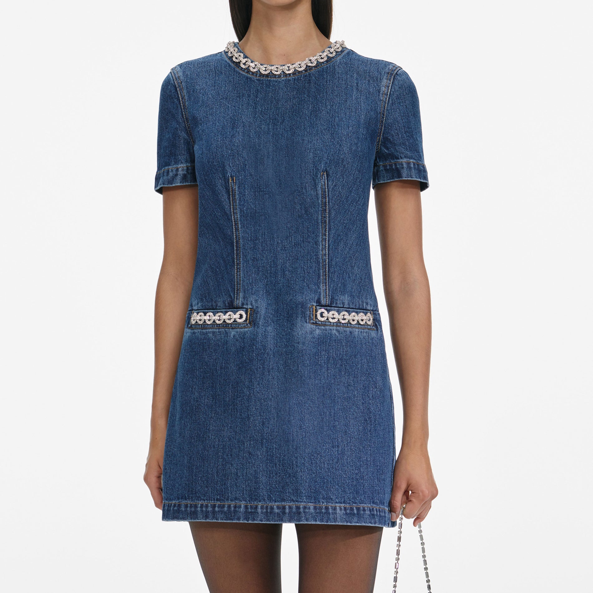 A close up of a woman wearing the Denim Crystal Trim Mini Dress