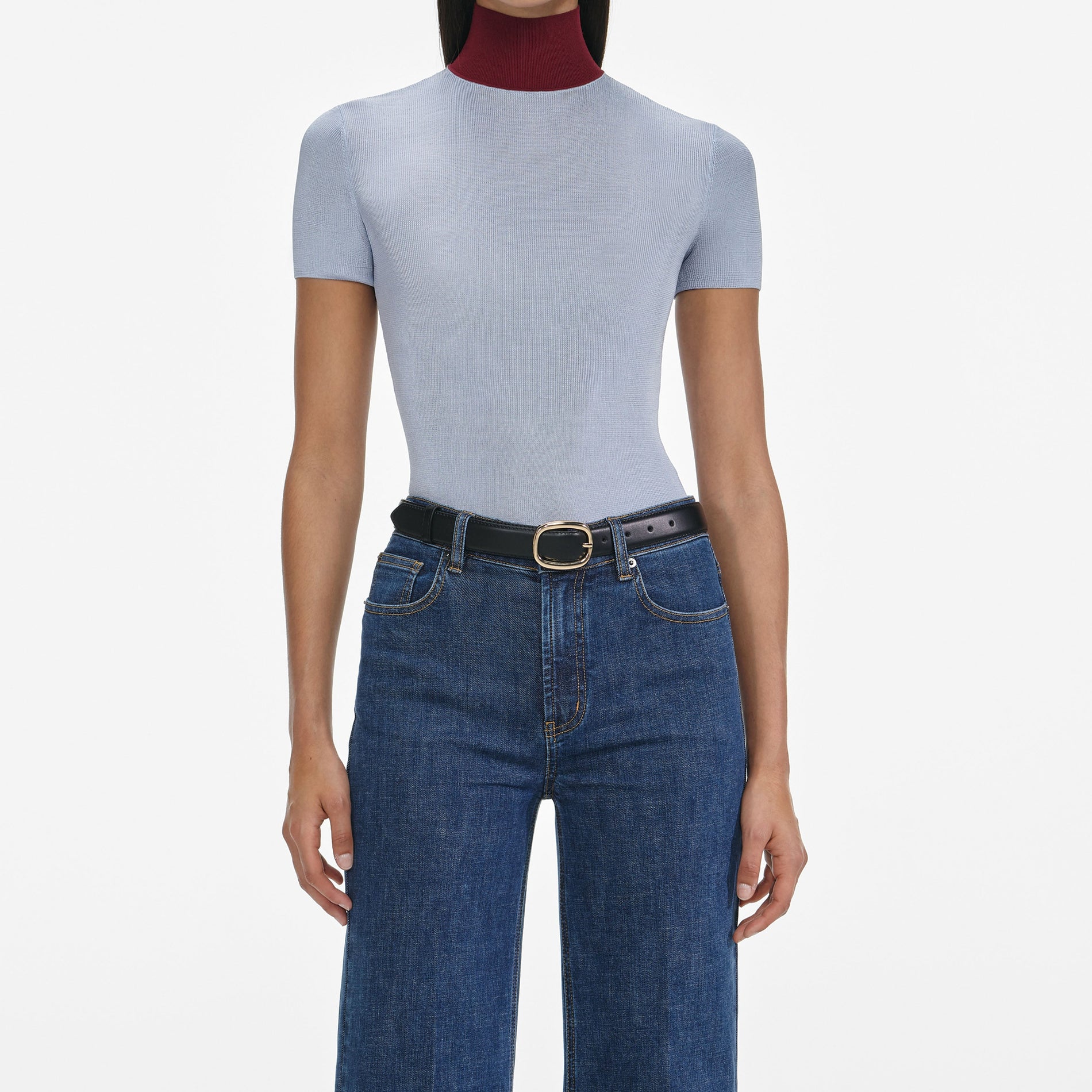 A close up of a woman wearing the Blue Flared Jeans