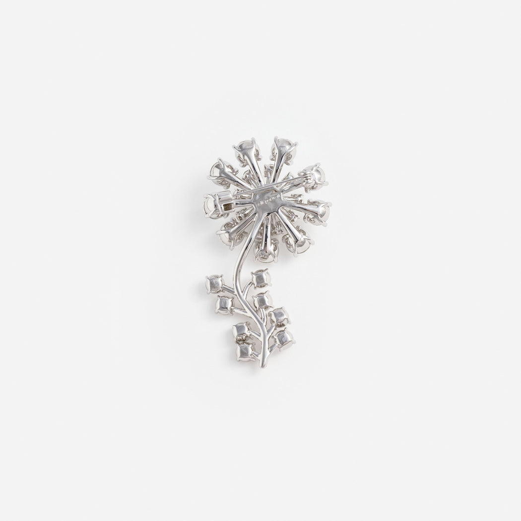 Back of a silver brooch with a flower and stem design, showing the pin and clasp mechanism