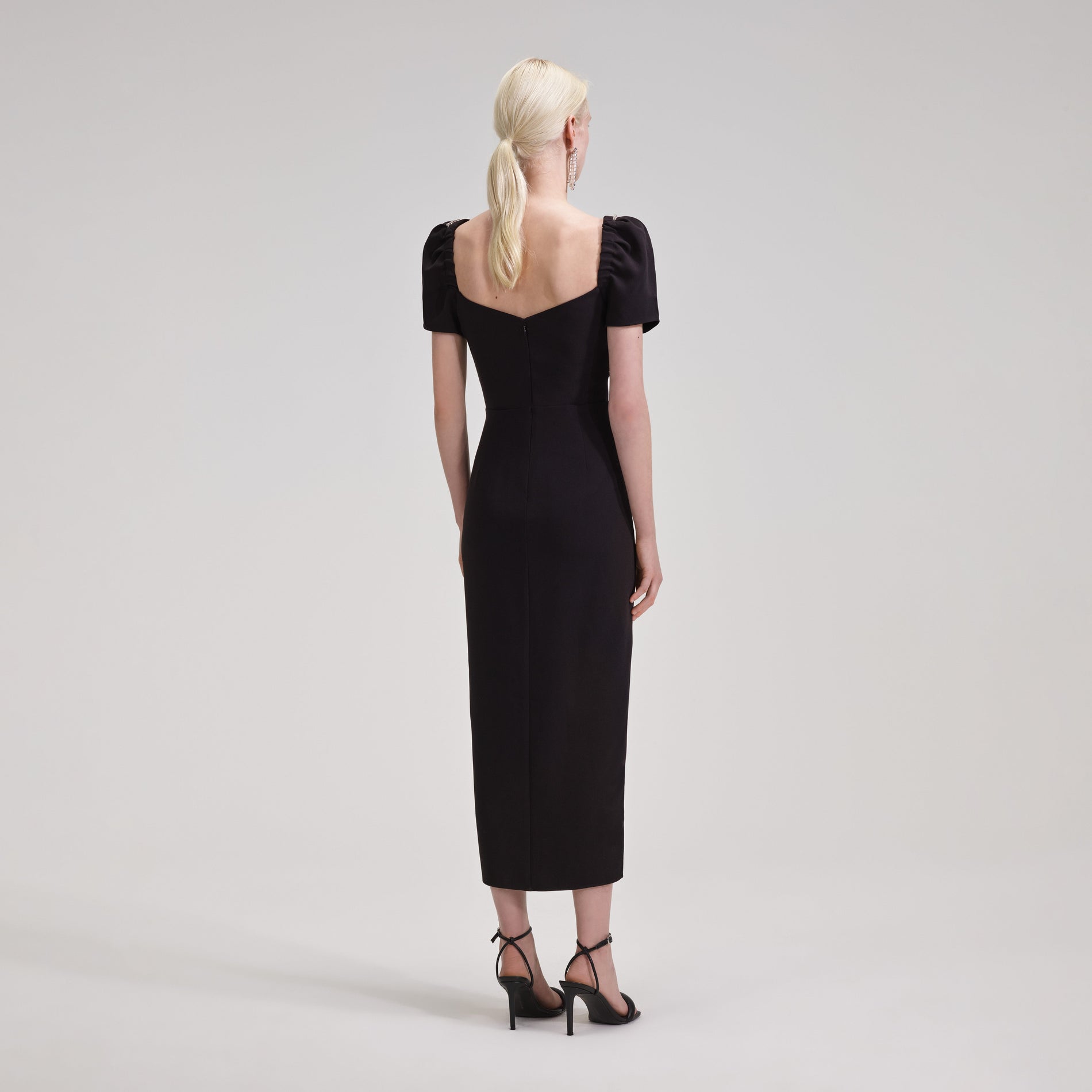 A woman wearing the Black Diamante Bust Midi Dress