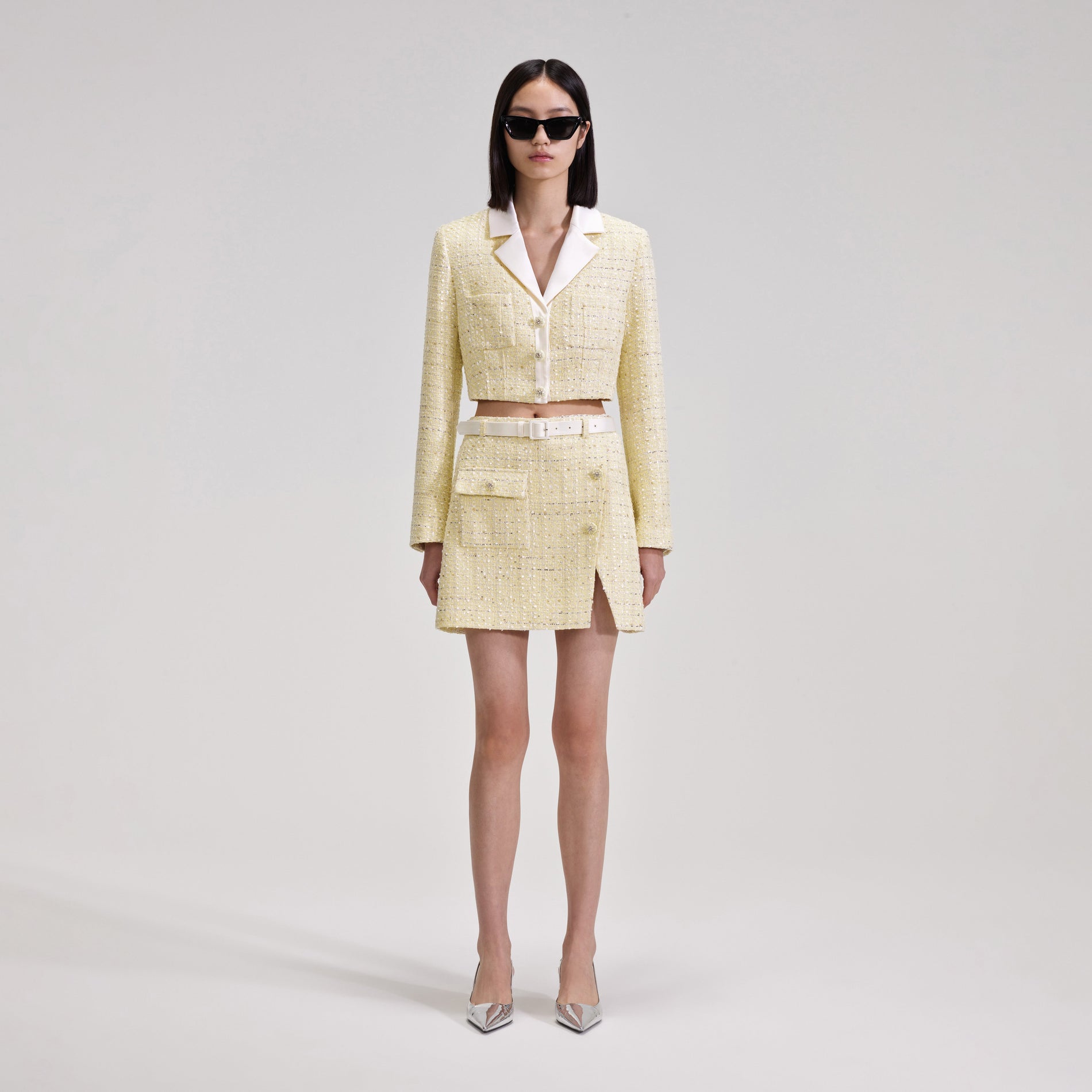 A woman wearing the Yellow Boucle Mini Skirt