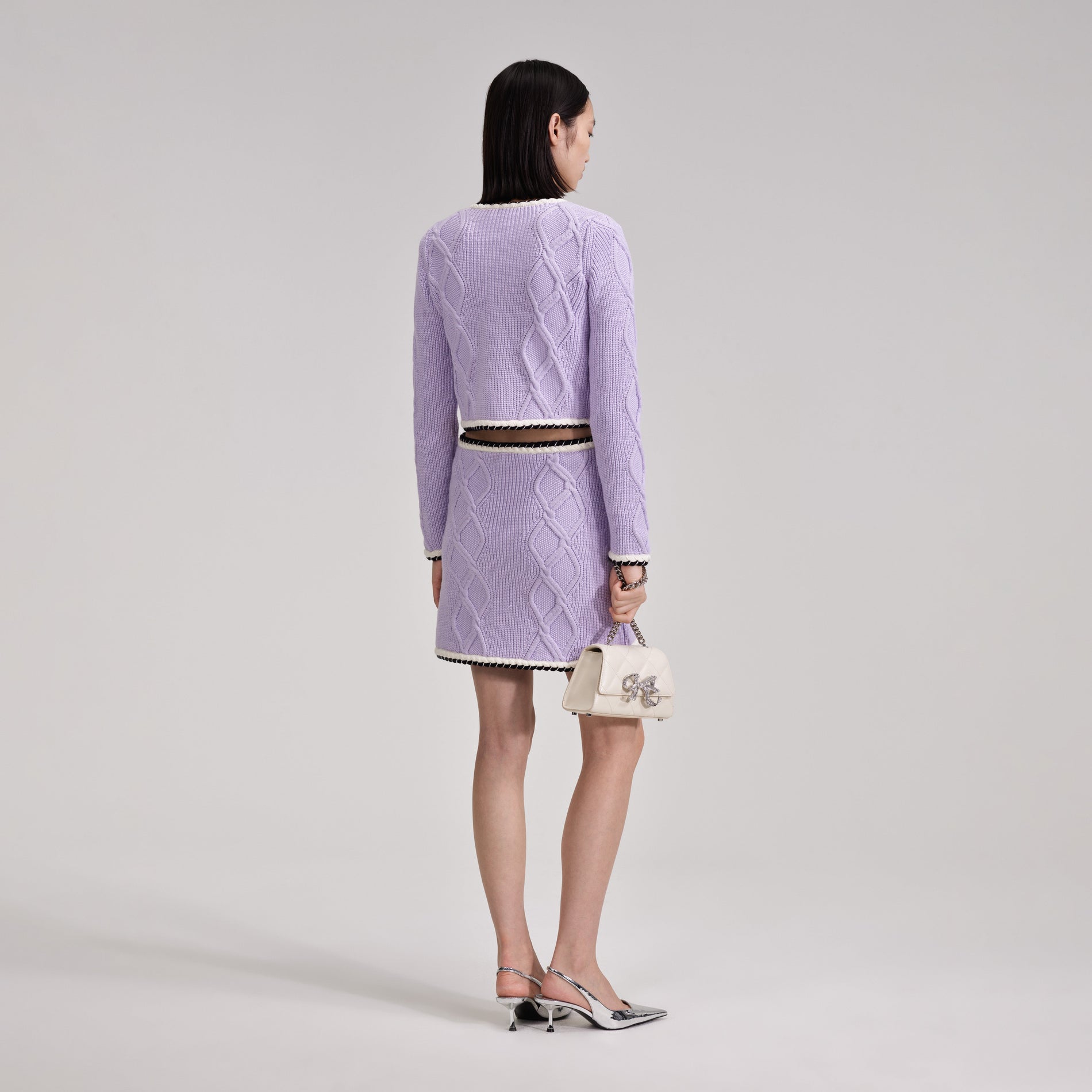 A woman wearing the Lilac Knit Mini Skirt