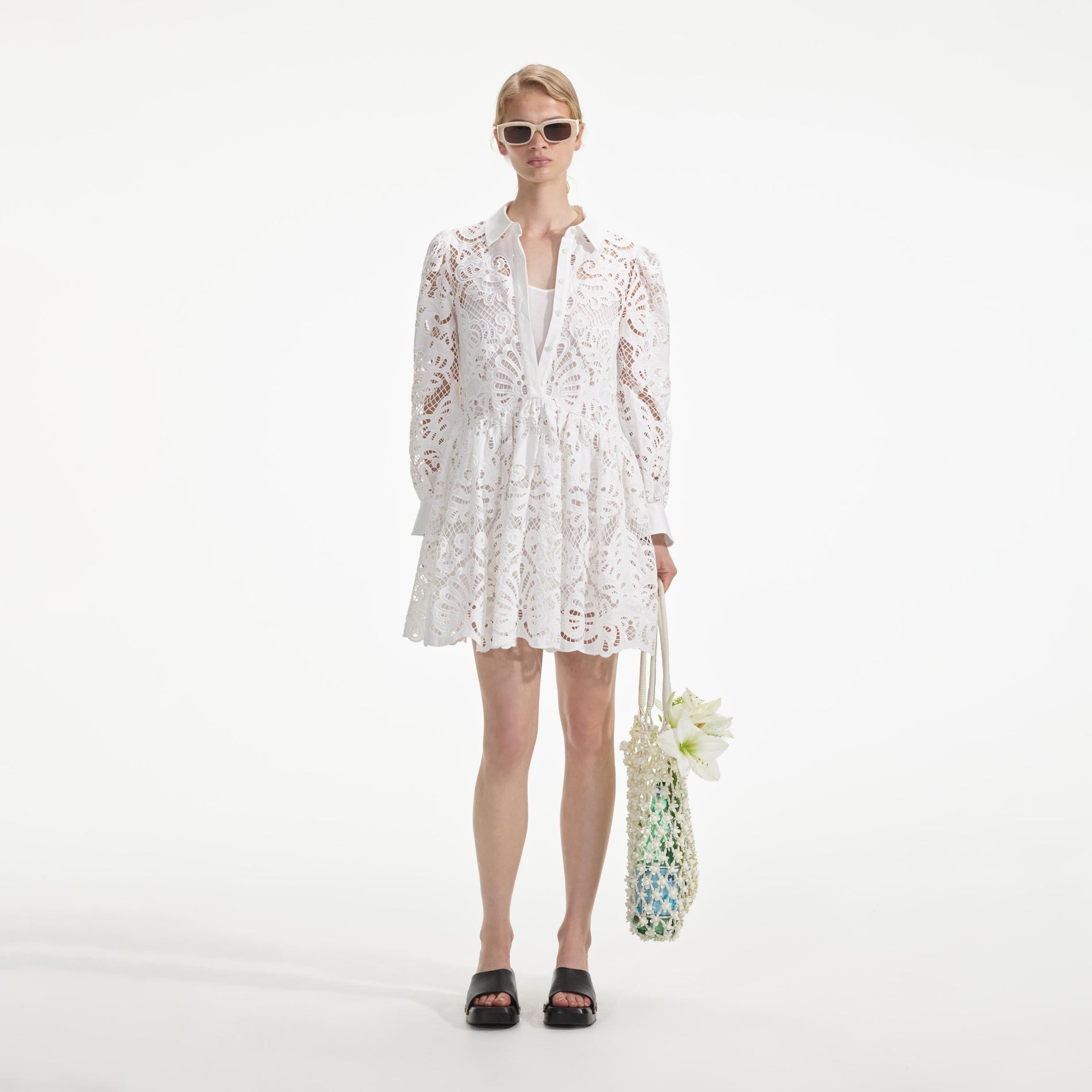 Front view of a woman wearing the White Cotton Lace Mini Shirt Dress