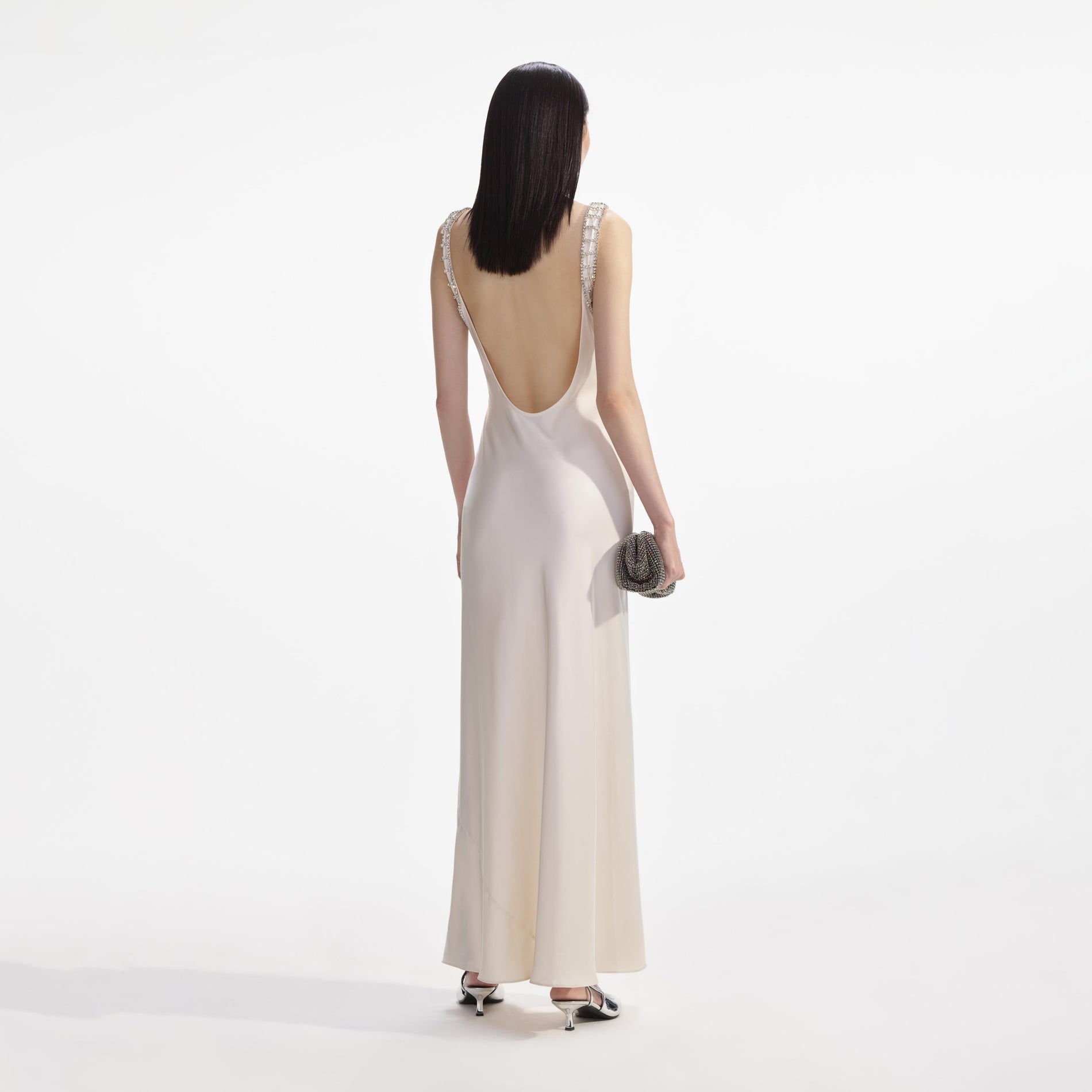 Back view of a woman wearing the Cream Satin Diamante Bralette Maxi Dress