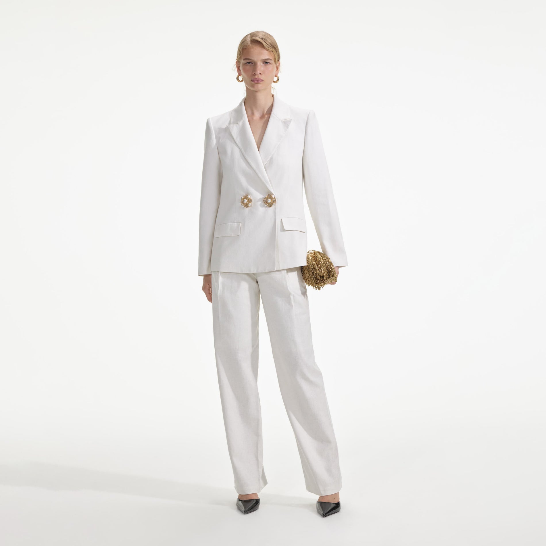 Front view of a woman wearing the White Linen Trousers