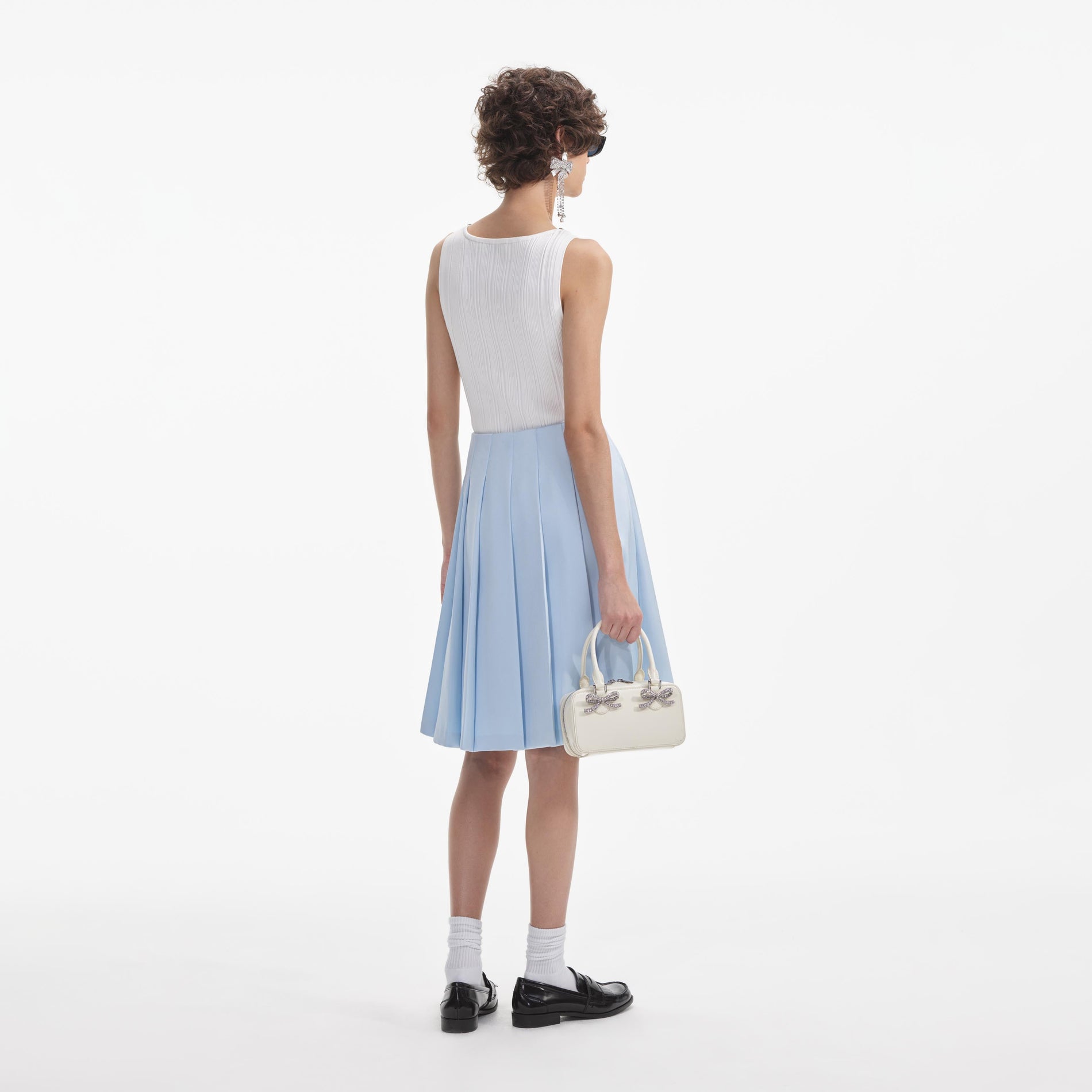 Back view of a woman wearing the White Blue Satin Midi Skirt