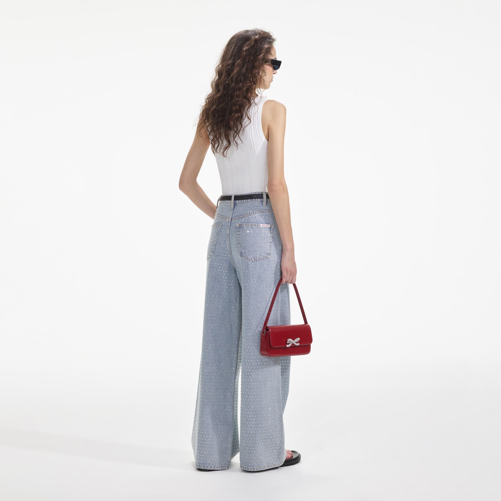 Back view of a woman wearing the Blue Rhinestone Wide Leg Jeans