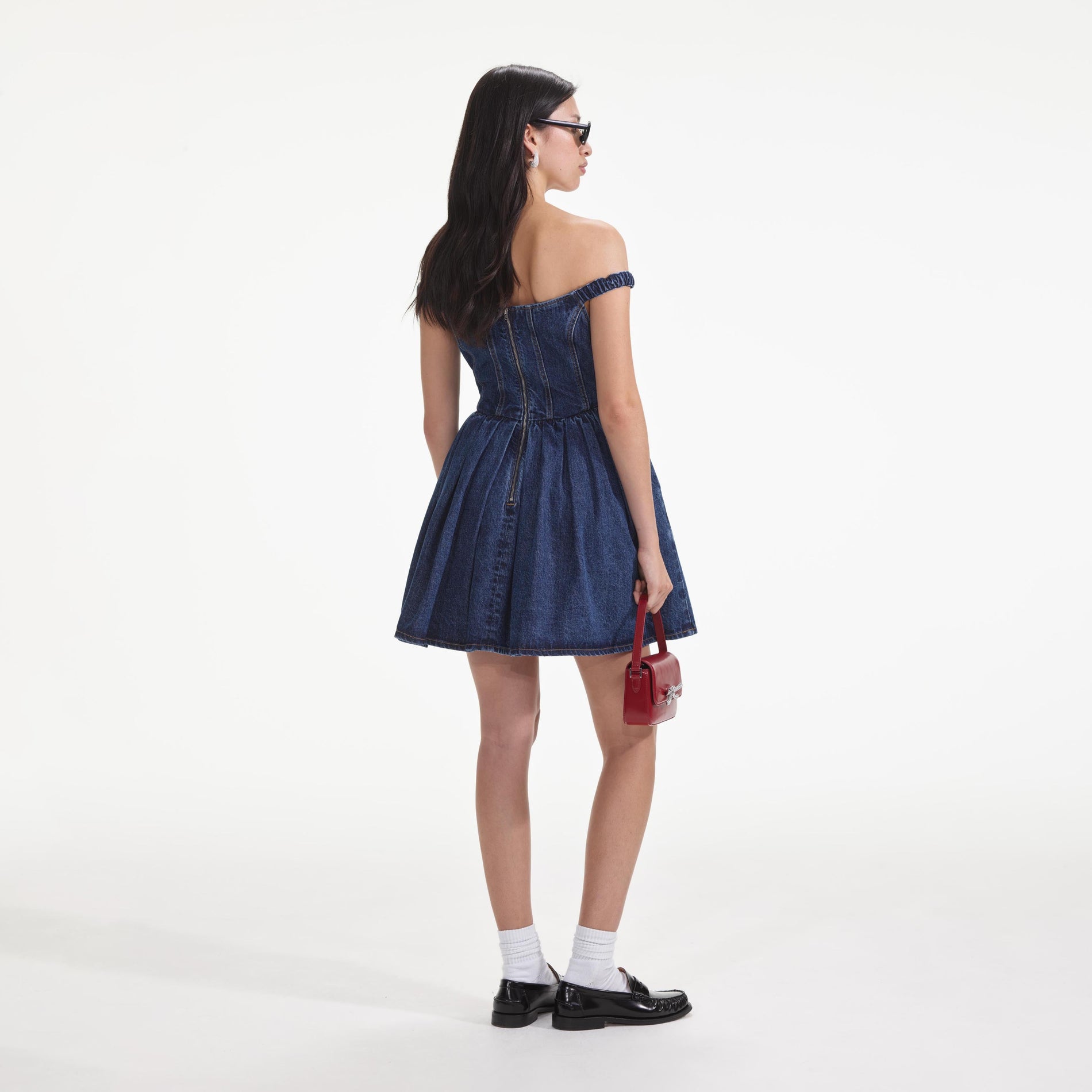 Back view of a woman wearing the Denim Off Shoulder Mini Dress