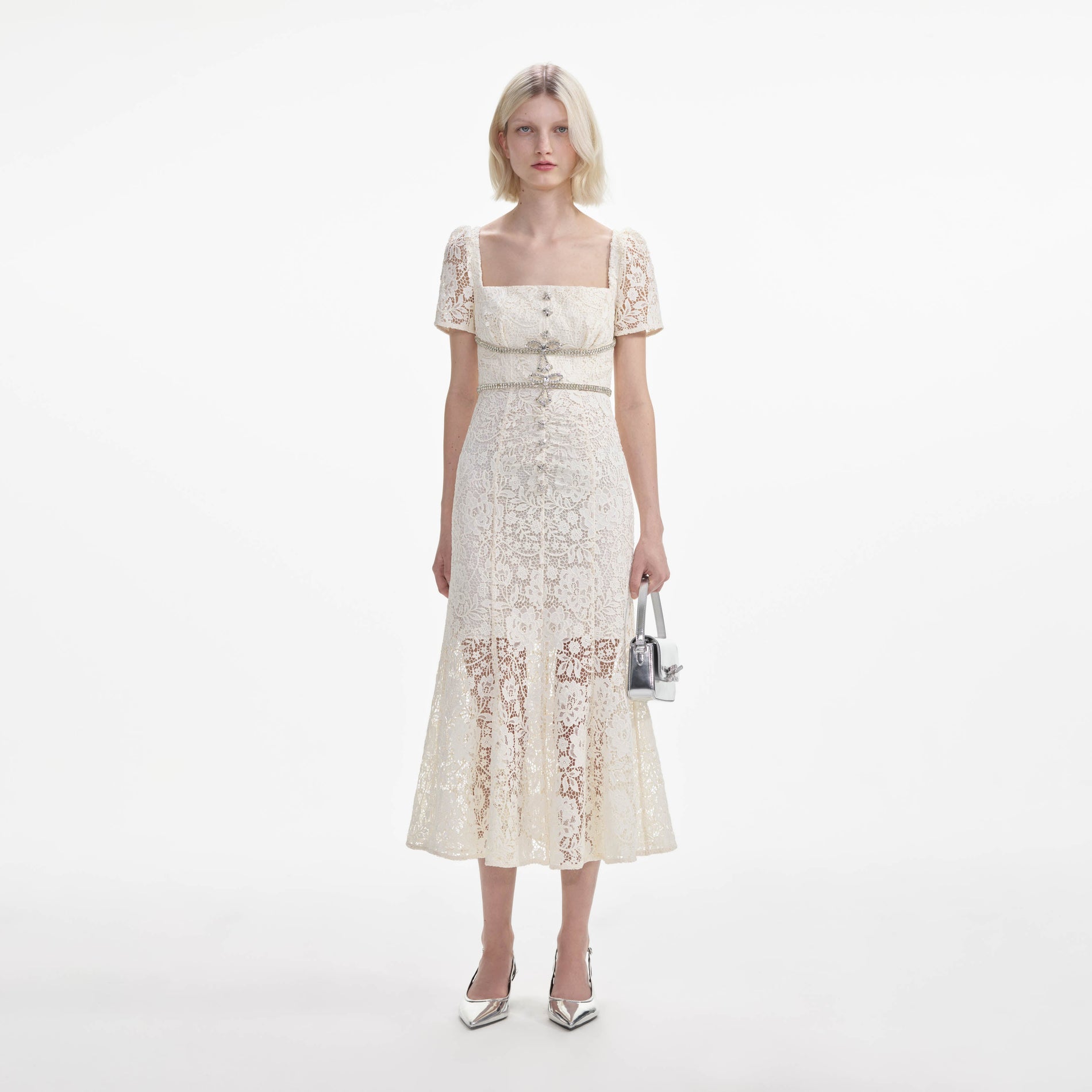 Front view of a woman wearing the Cream Lace Diamante Bow Midi Dress