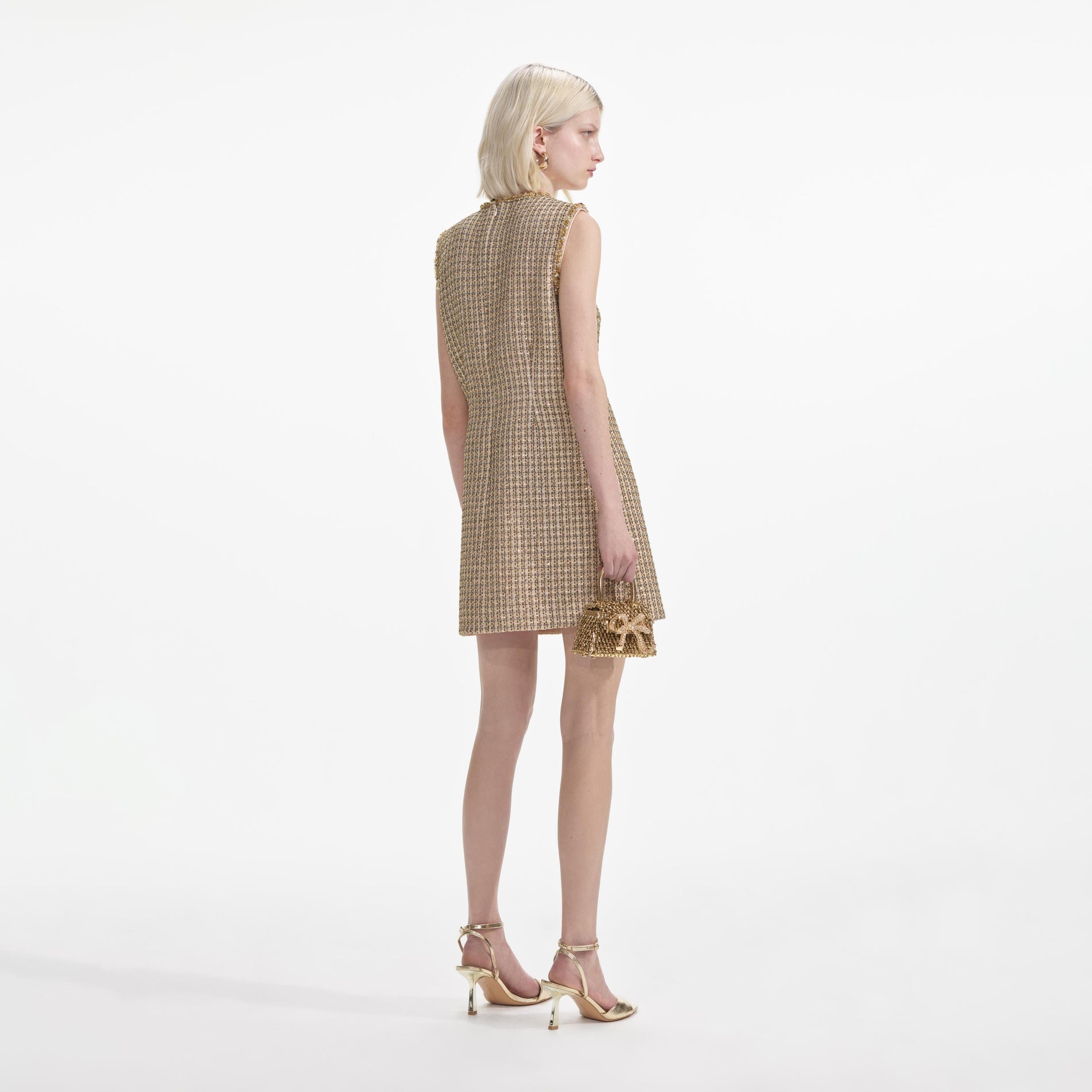 Back view of a woman wearing the Gold Boucle Embellished Mini Dress