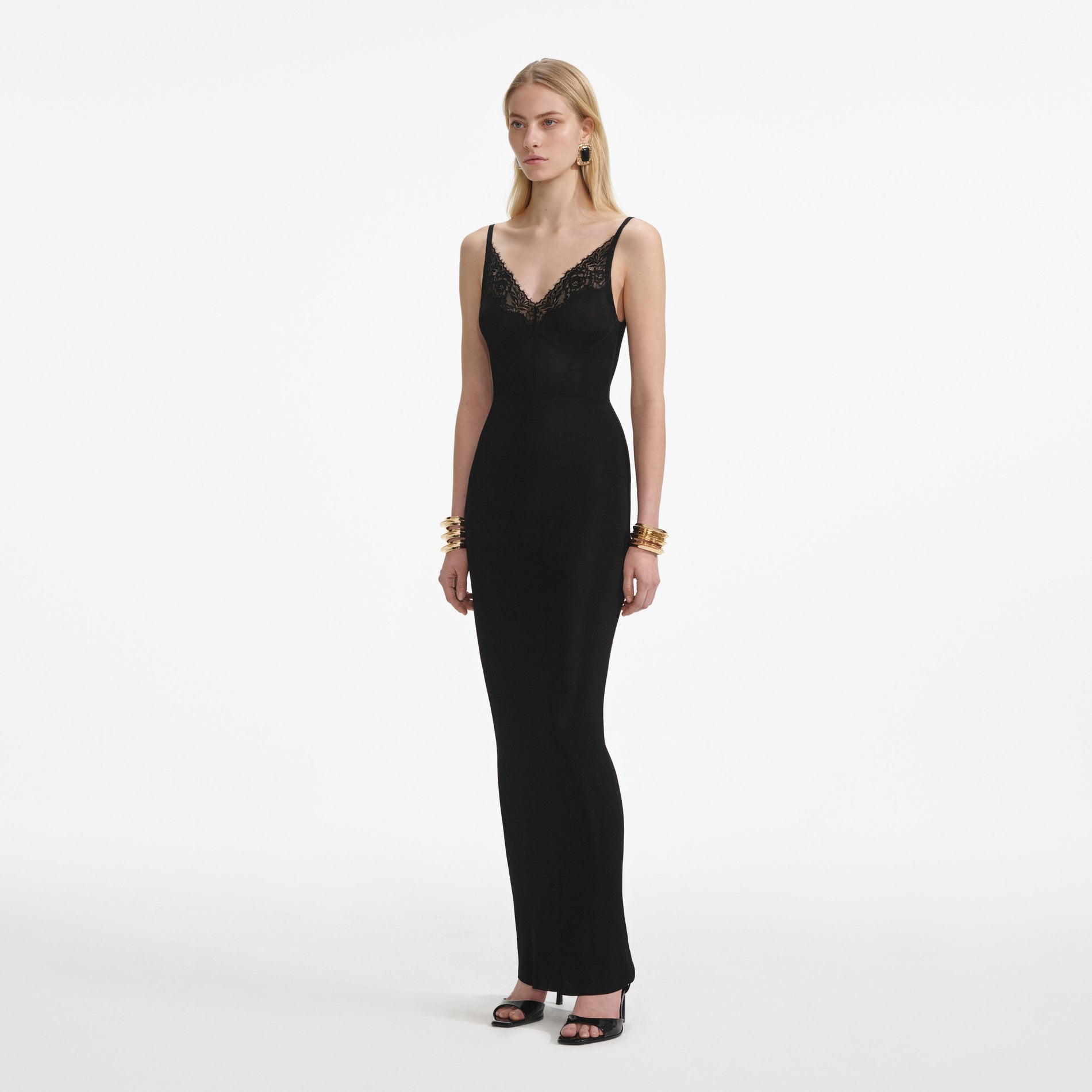 Side view of a woman wearing the Black Viscose Knit Maxi Dress