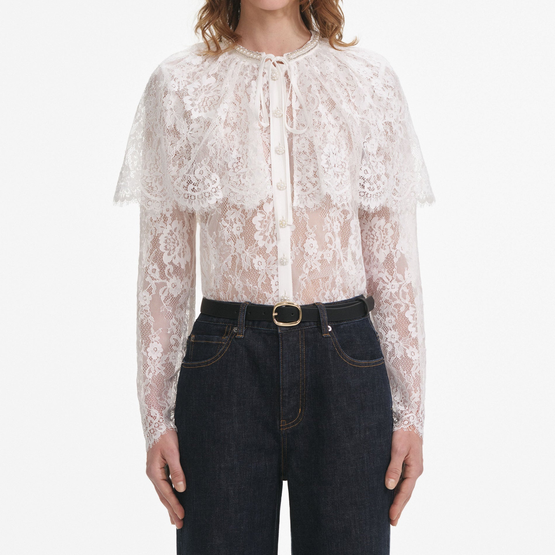 A close up of a woman wearing the White Lace Cape Top