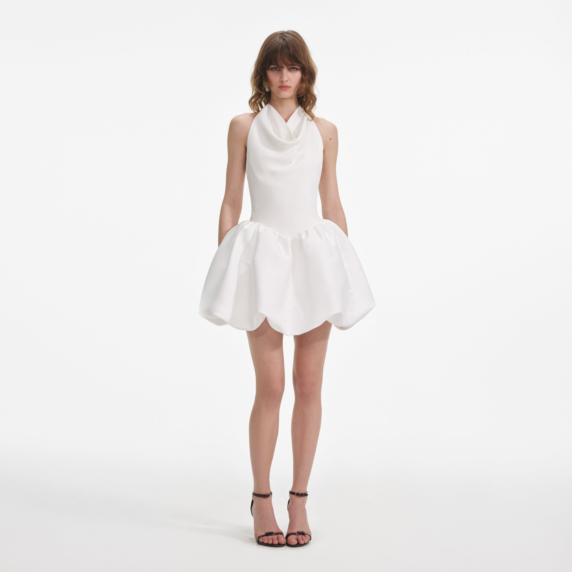 Front view of a woman wearing the White Halter Neck Mini Dress