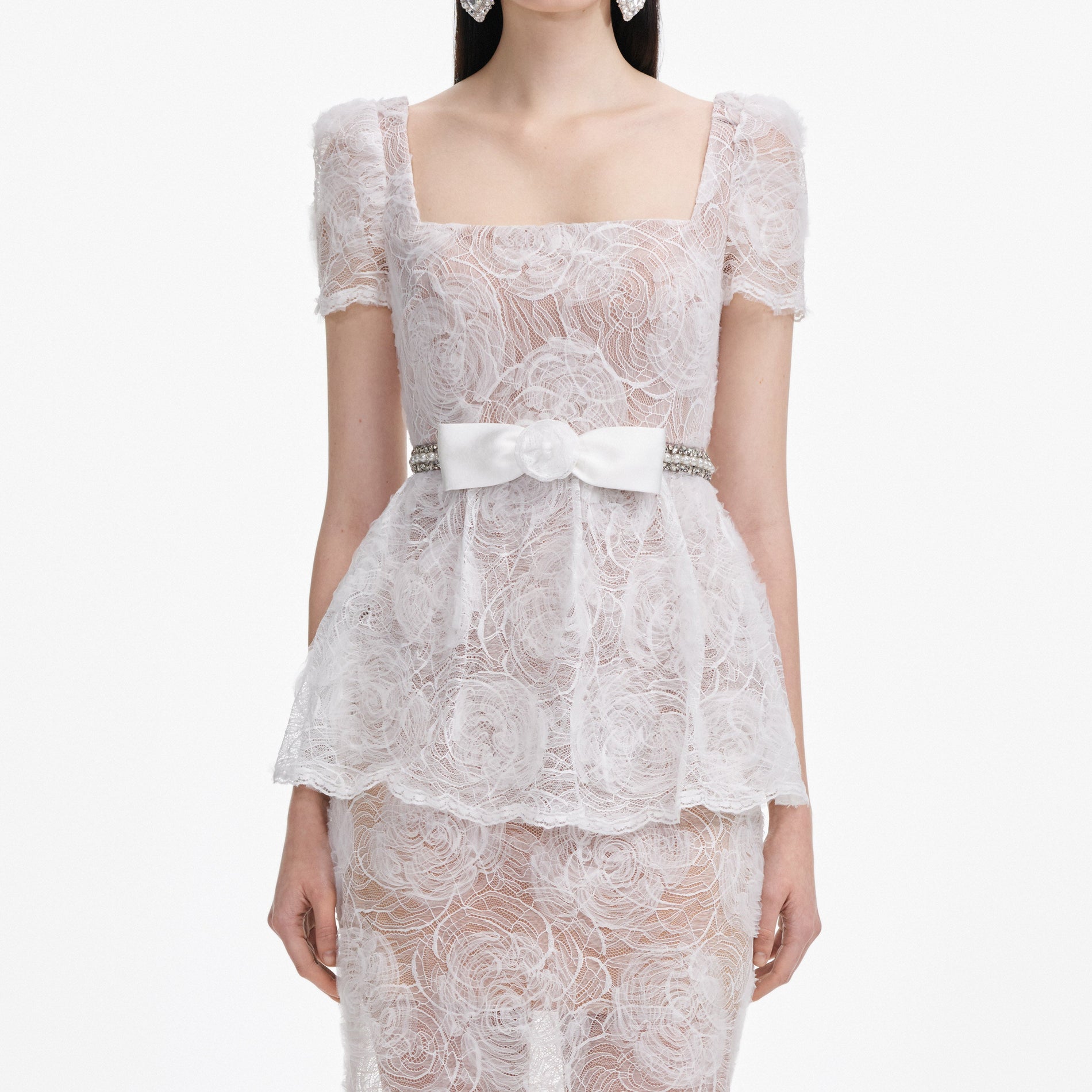 A close up of a woman wearing the White Tulle Lace Maxi Dress