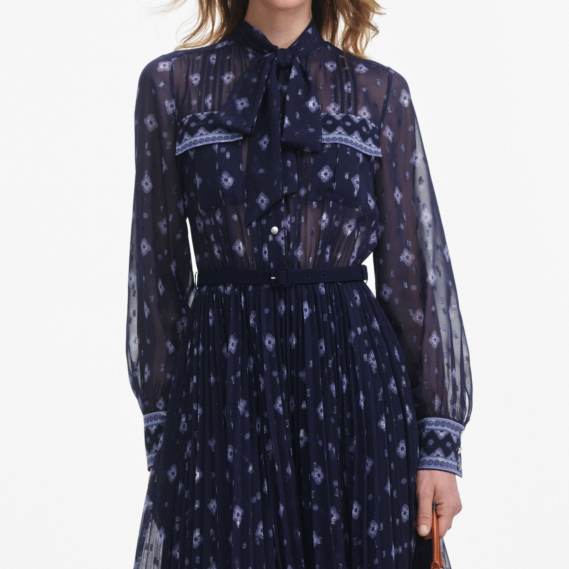 A close up of a woman wearing the Navy Printed Chiffon Midi Dress