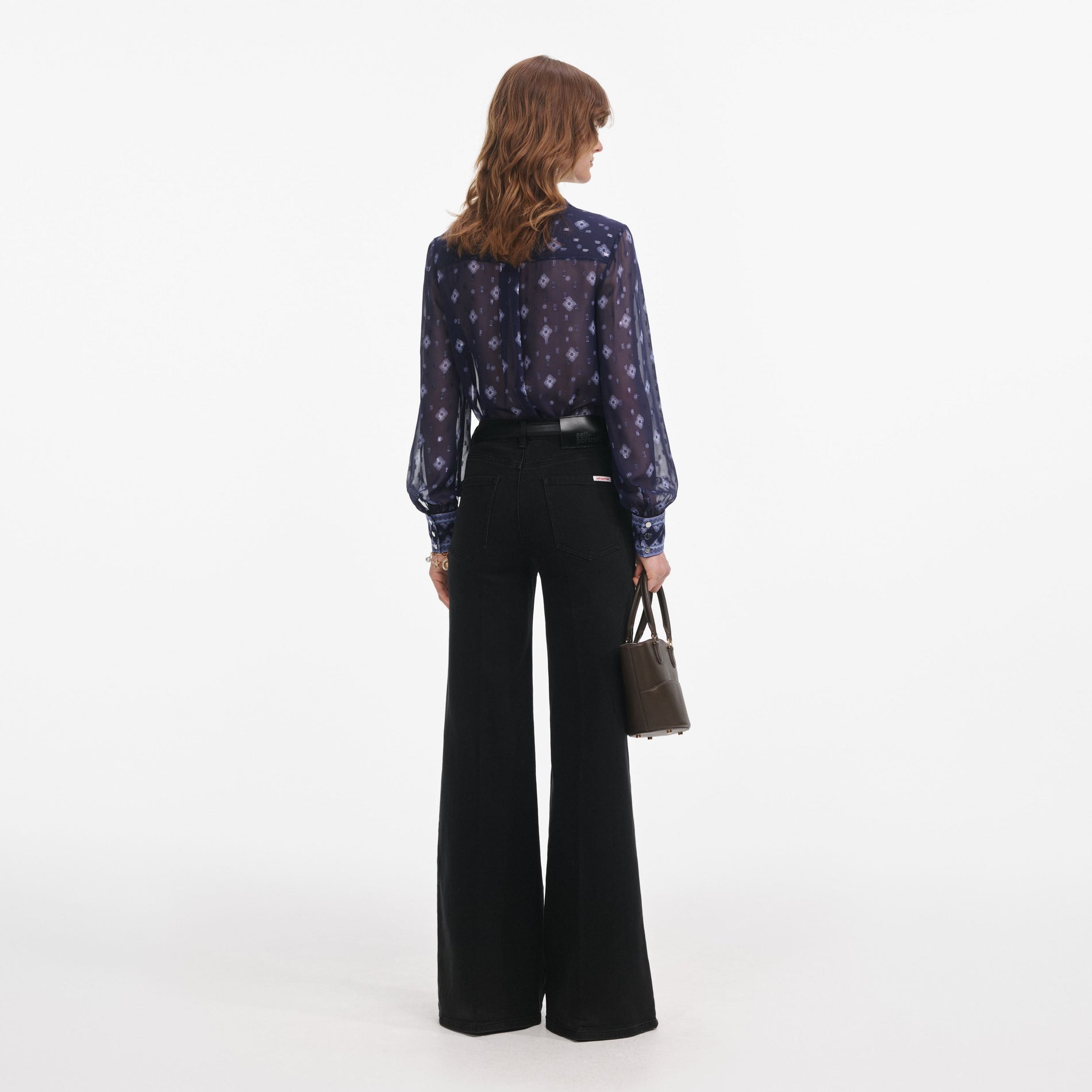 Back view of a woman wearing the Navy Printed Chiffon Blouse