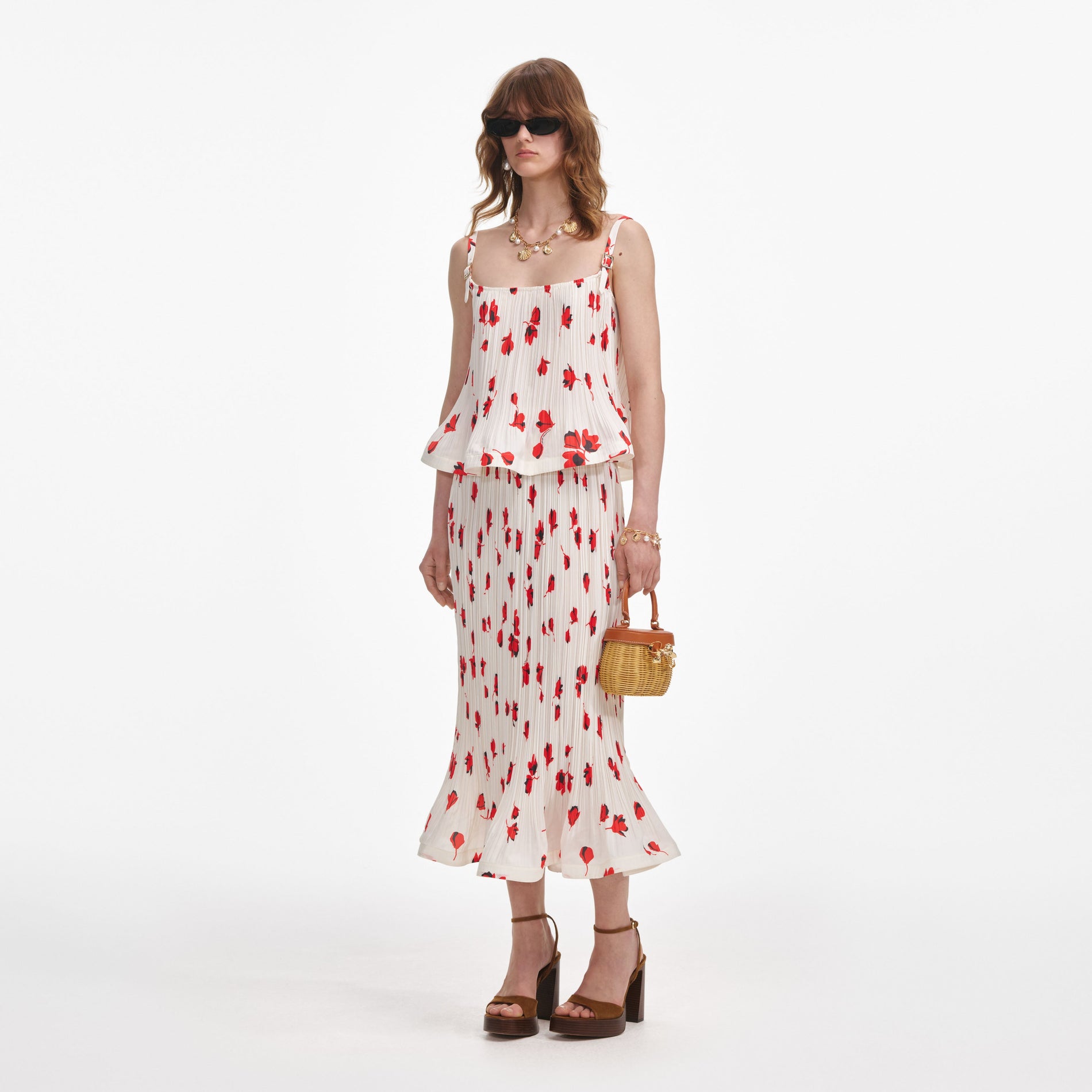 Side view of a woman wearing the White Floral Plisse  Midi Skirt