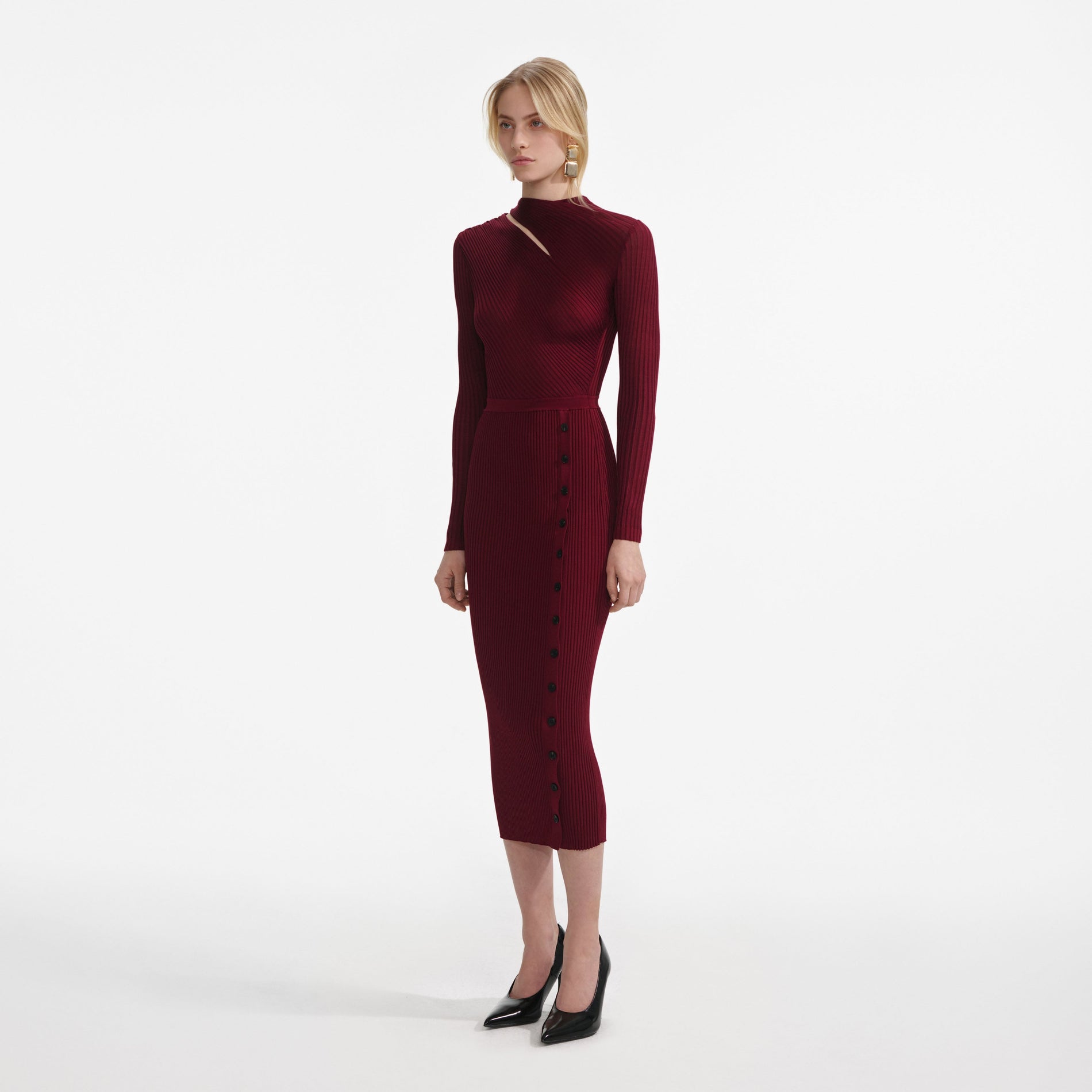Side view of a woman wearing the Burgundy Cut Out Rib Knit Midi Dress