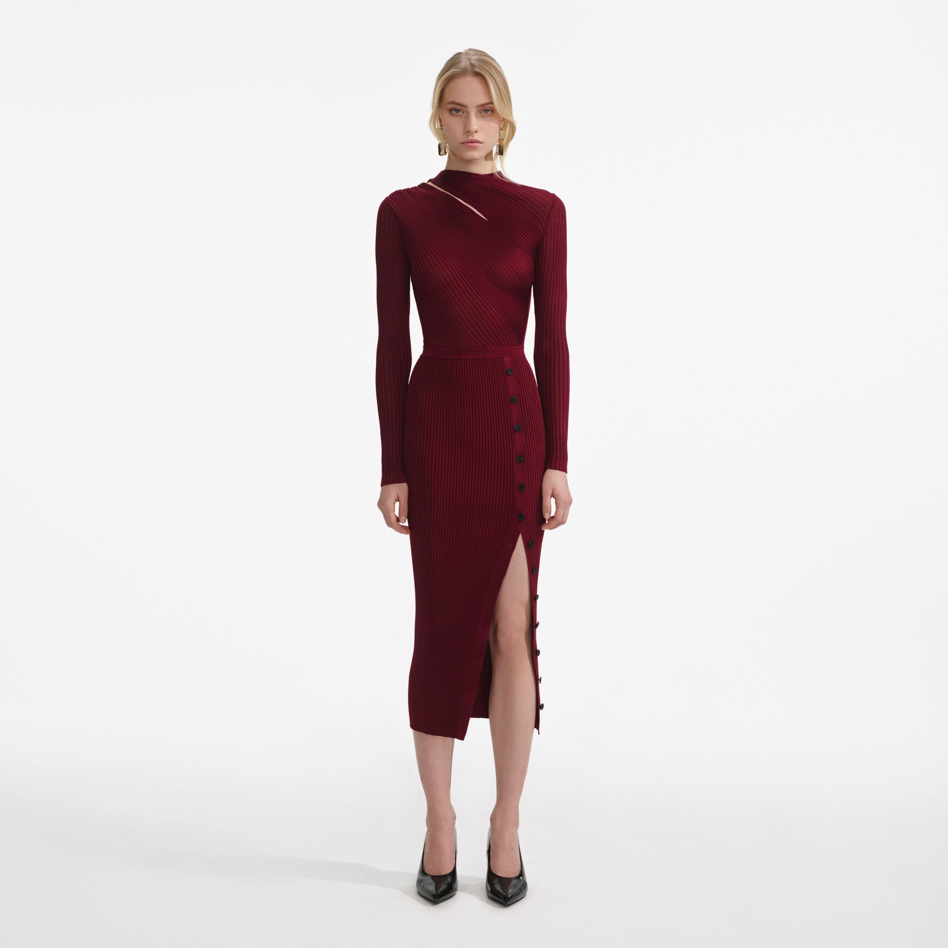 A close up of a woman wearing the Burgundy Cut Out Rib Knit Midi Dress