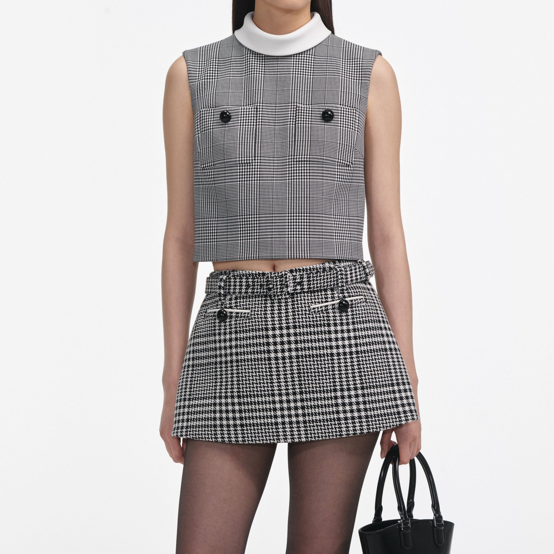 A close up of a woman wearing the Houndstooth Skort