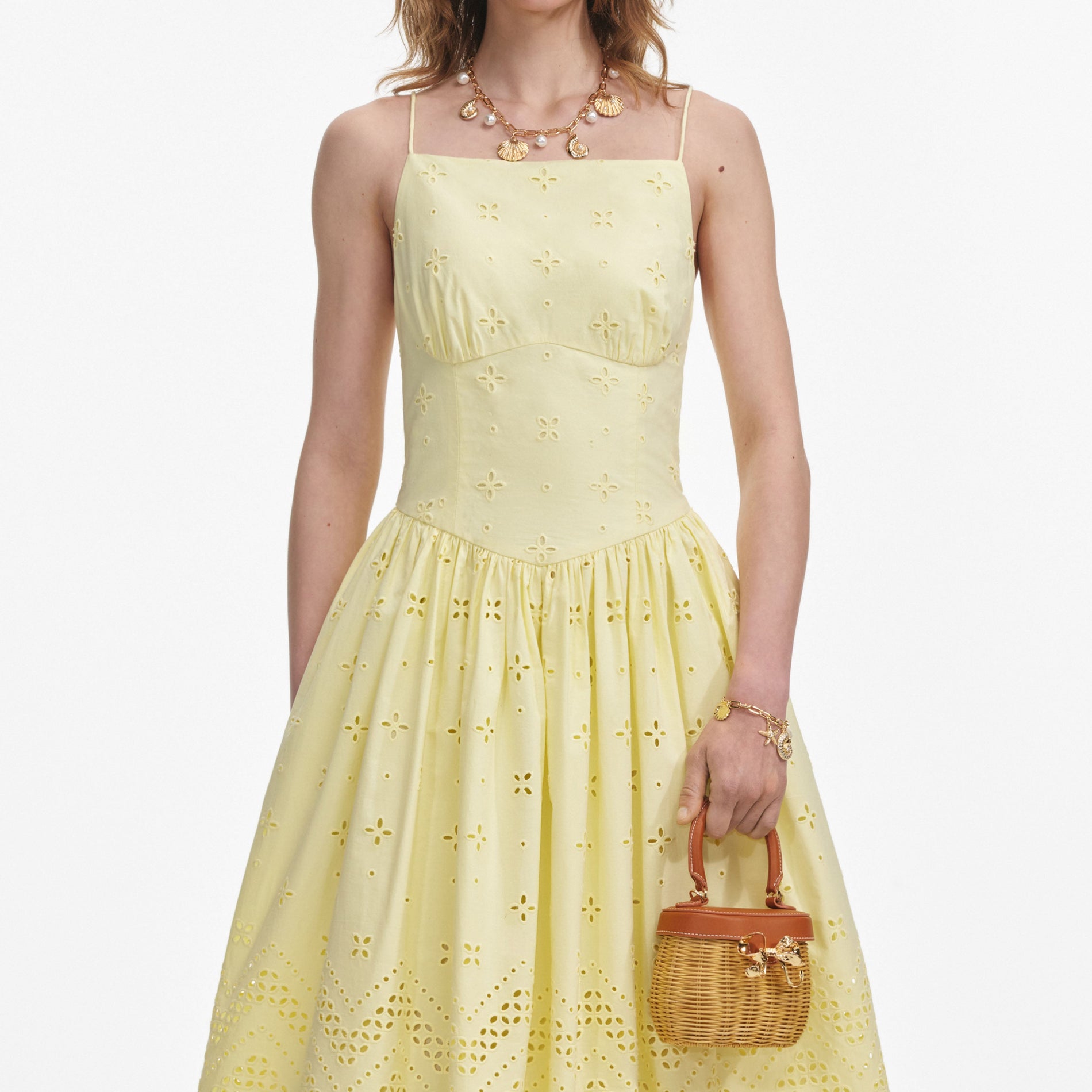 A close up of a woman wearing the Yellow Cotton Broderie Midi Dress