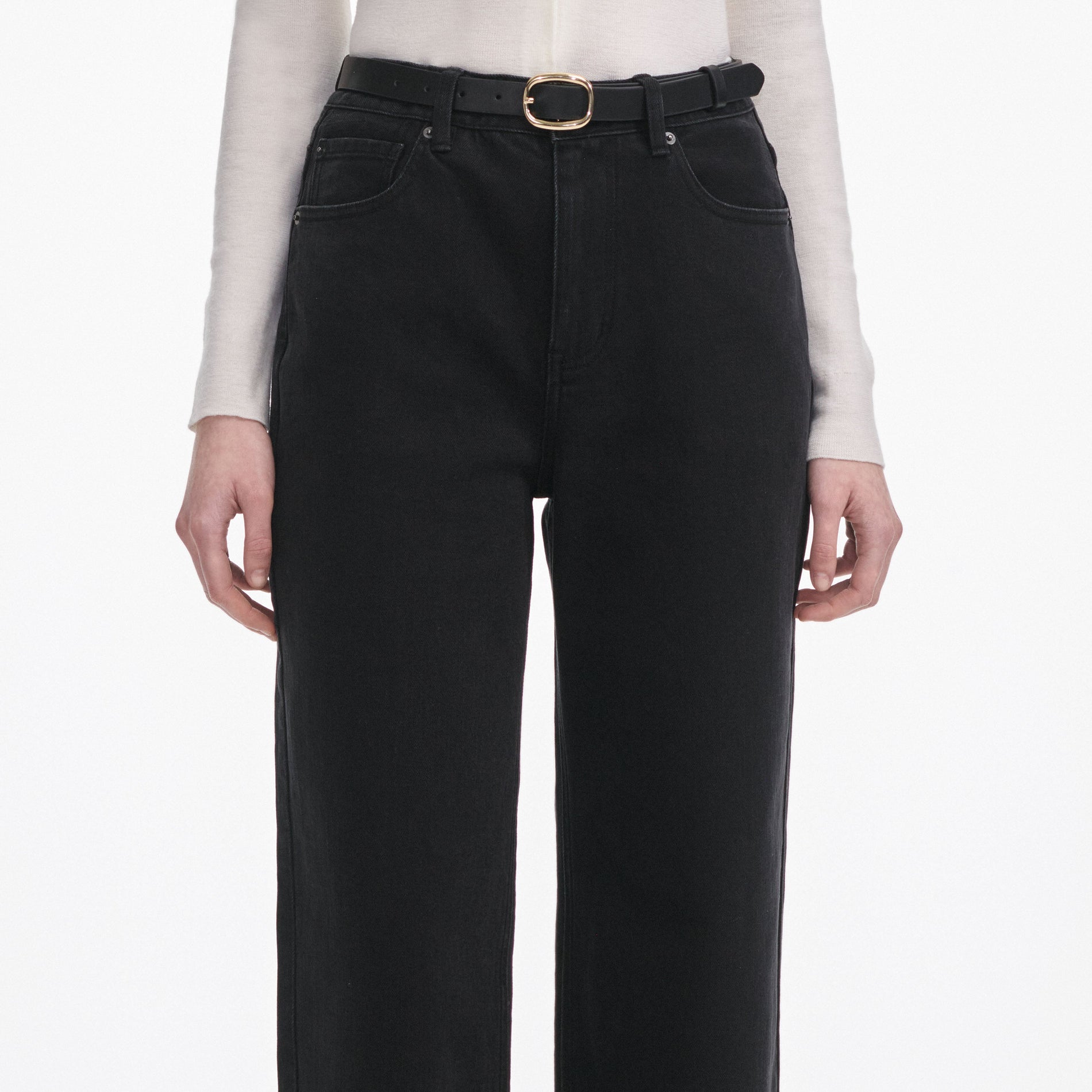 A close up of a woman wearing the Black Straight Leg Jeans