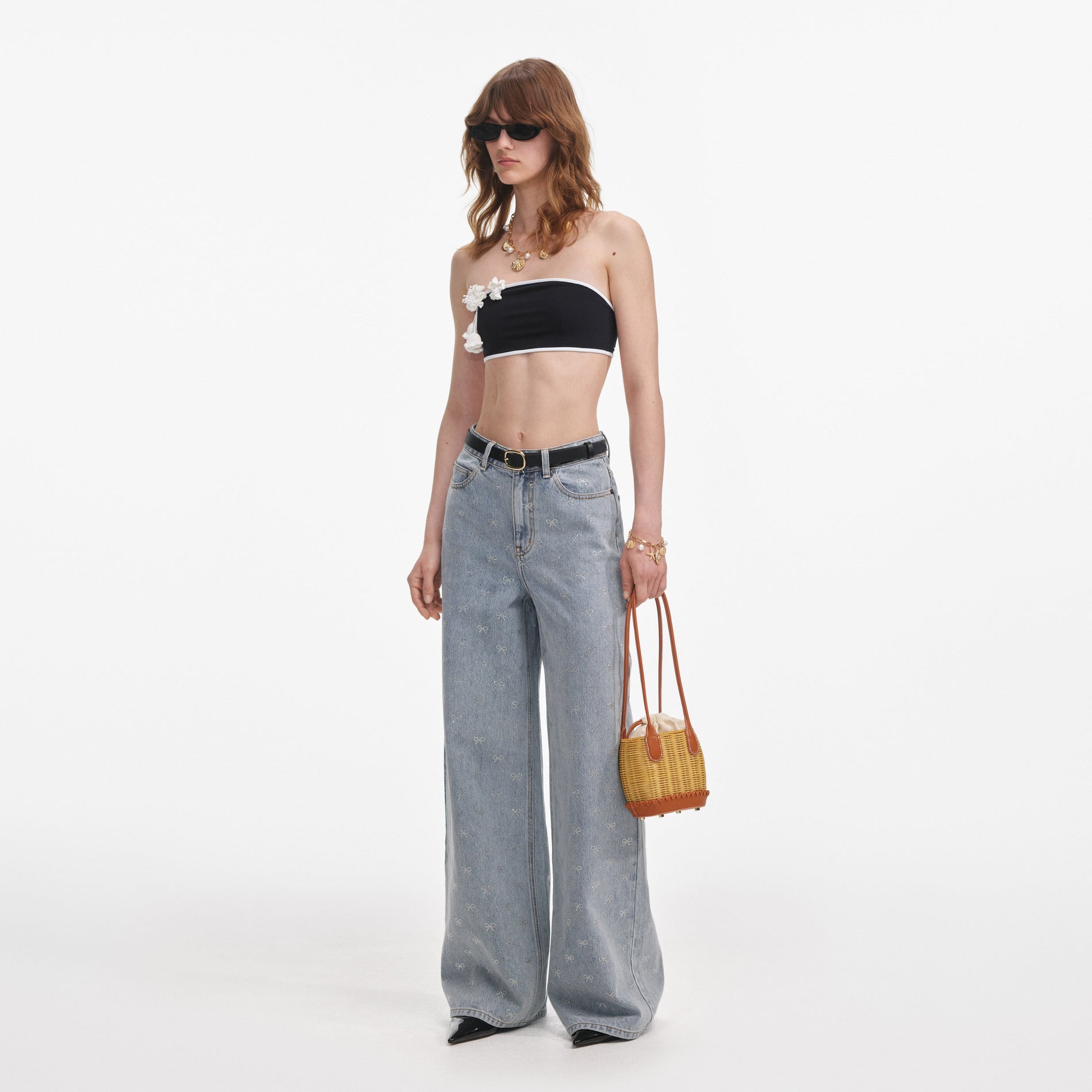 Side view of a woman wearing the Light Blue Diamante Bow Jeans