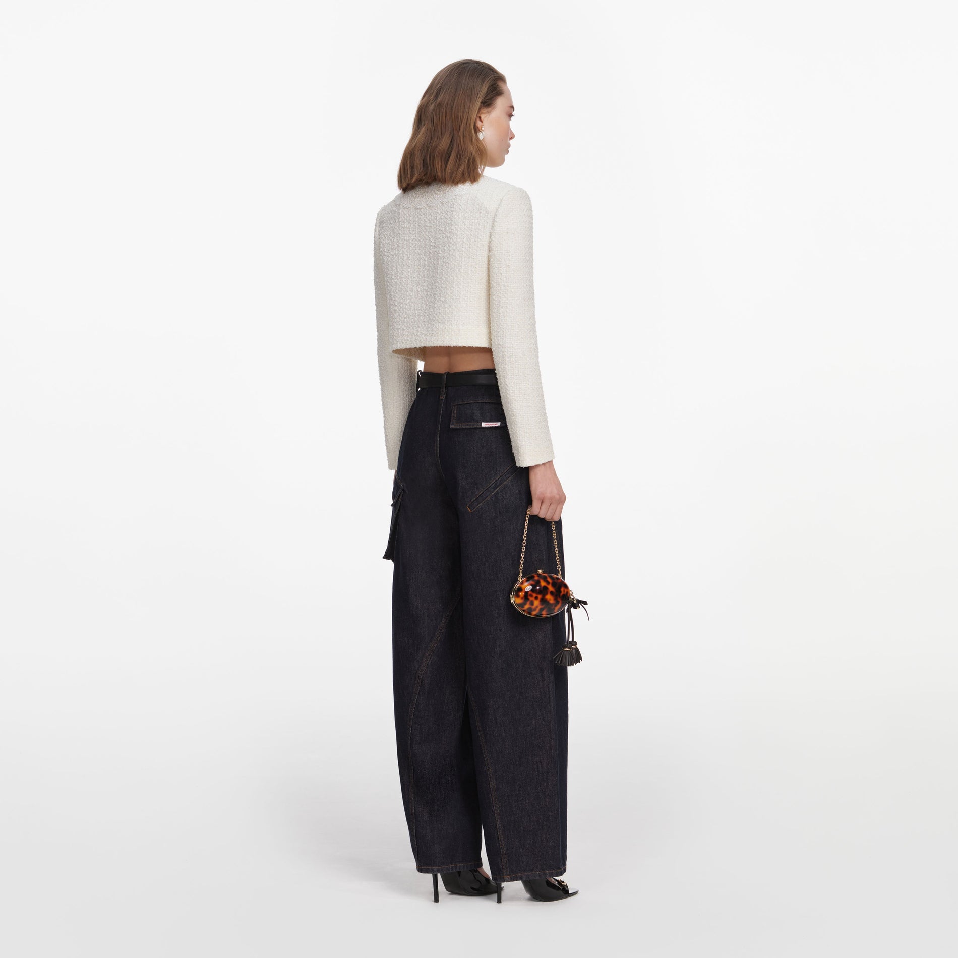 Back view of a woman wearing the Cream Boucle Lace Collar Jacket