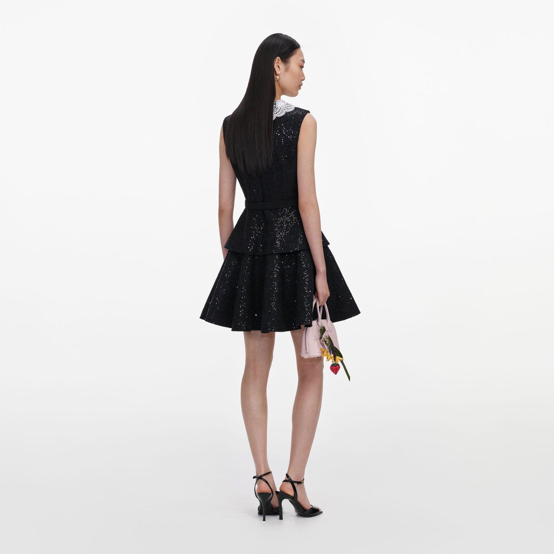 Back view of a woman wearing the Black Sequin Boucle Mini Dress