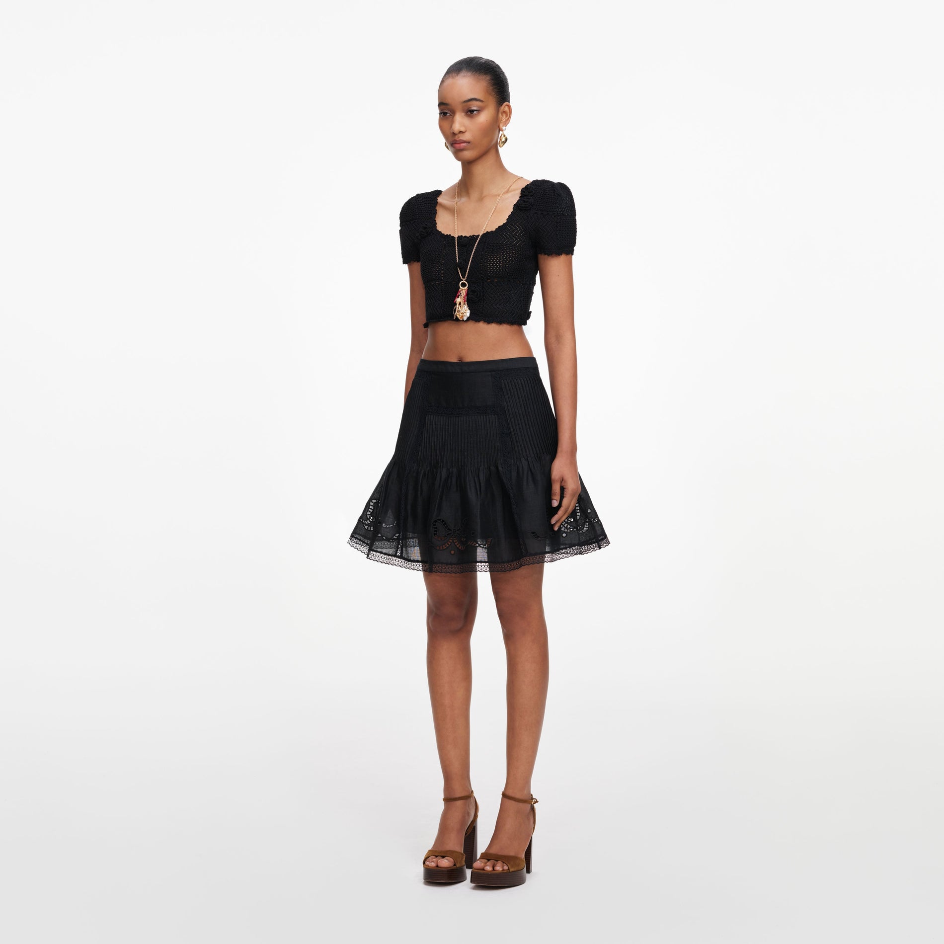 Side view of a woman wearing the Black Embroidered Mini Skirt