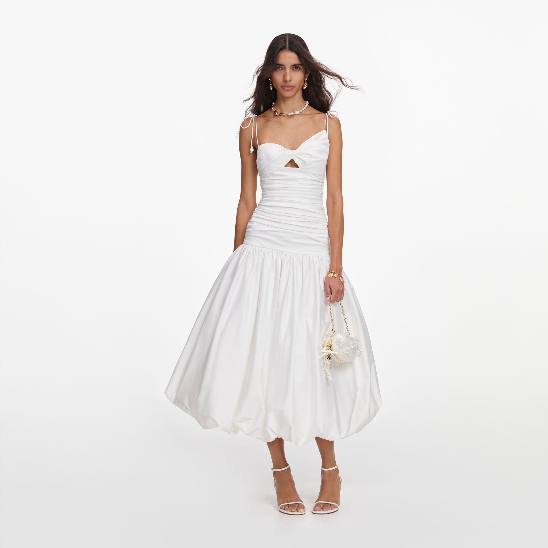 Front view of a woman wearing the White Cotton Gathered Midi Dress