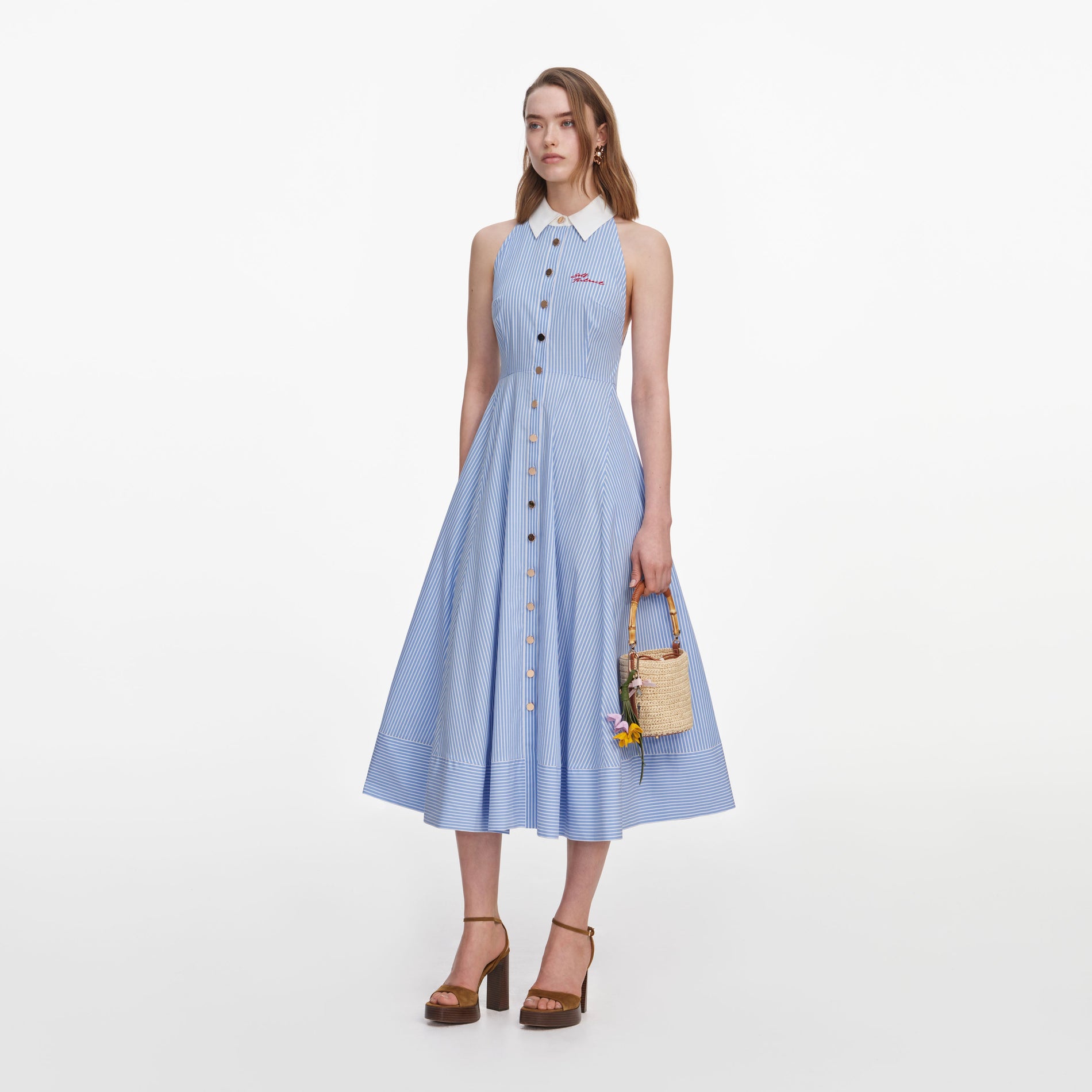 Side view of a woman wearing the Blue Striped Cotton Midi Dress