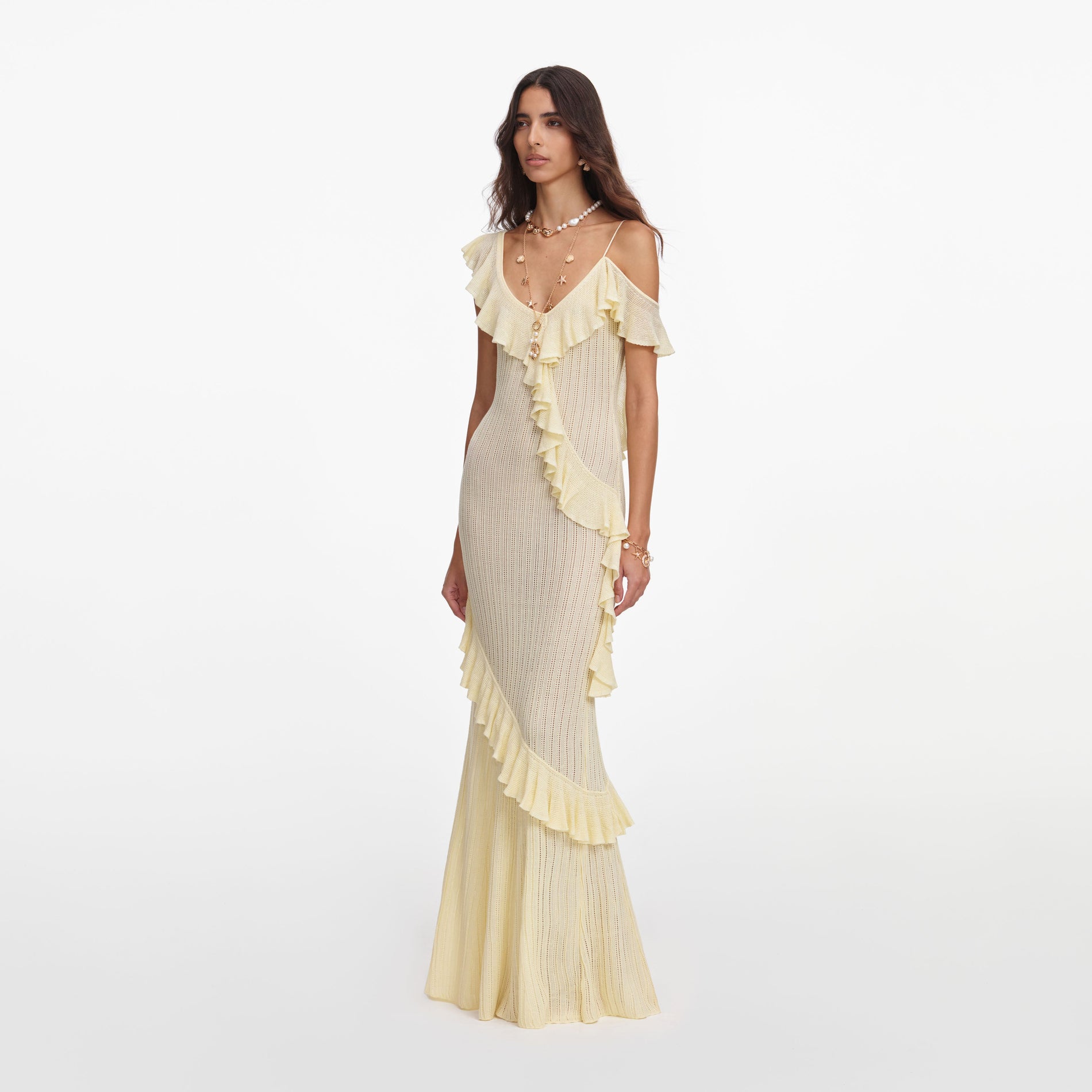 Side view of a woman wearing the Yellow Ruffle Knit Maxi Dress