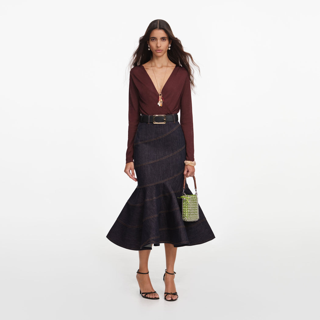 Front view of a woman wearing the Indigo Denim Belted Midi Skirt