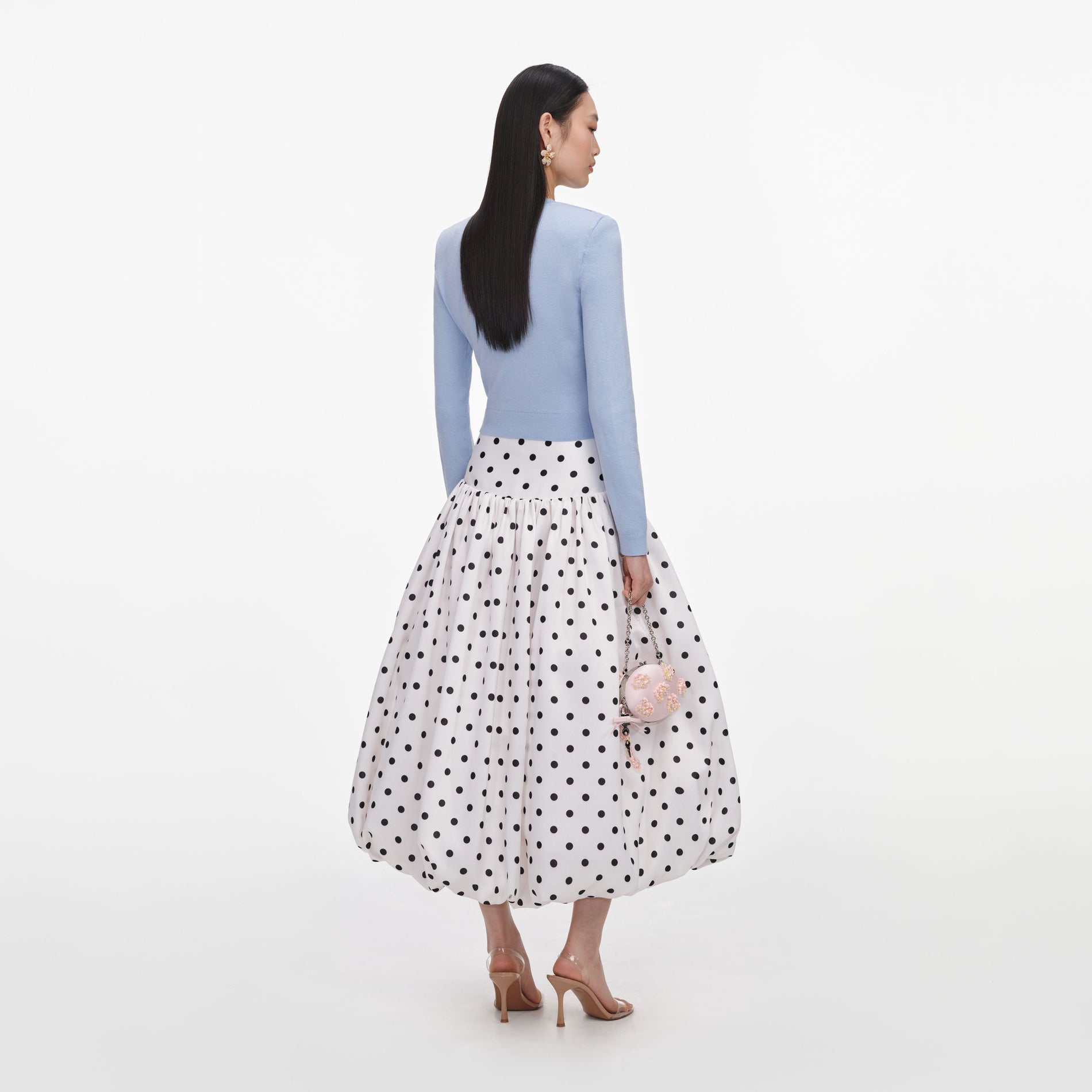 Back view of a woman wearing the Blue Flower Knit Cardigan