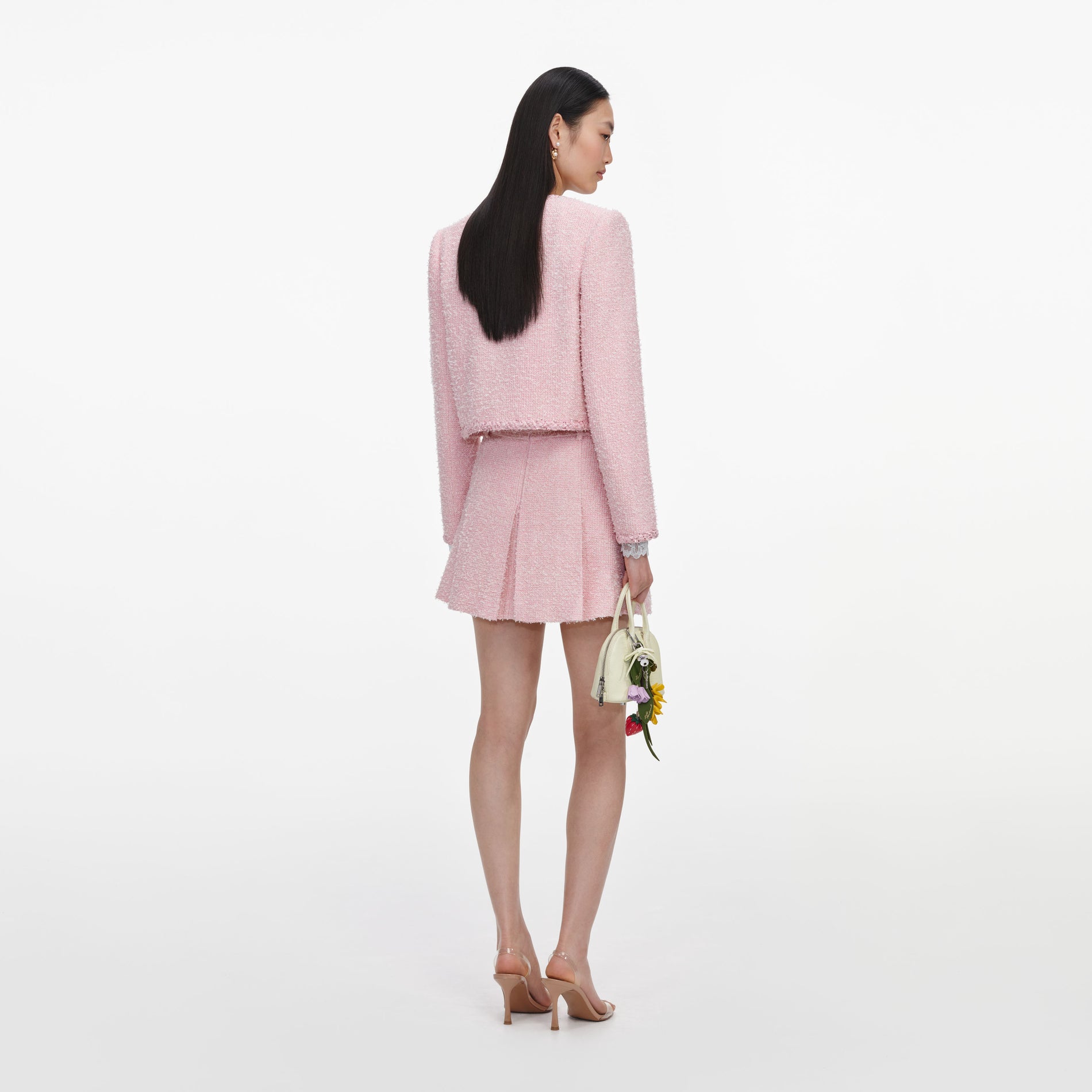 Back view of a woman wearing the Pink Boucle Jacket