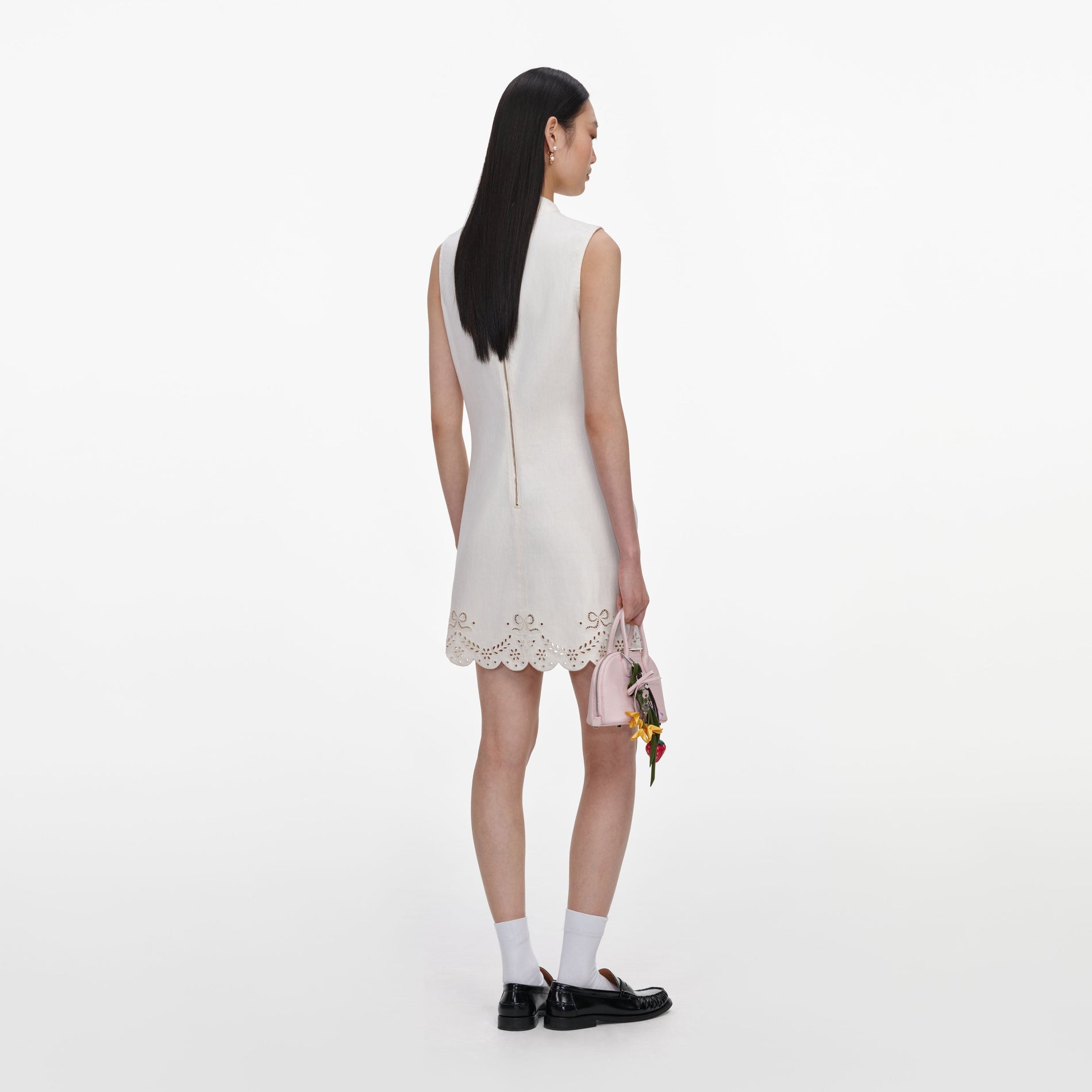 Back view of a woman wearing the Cream Broderie Denim Mini Dress