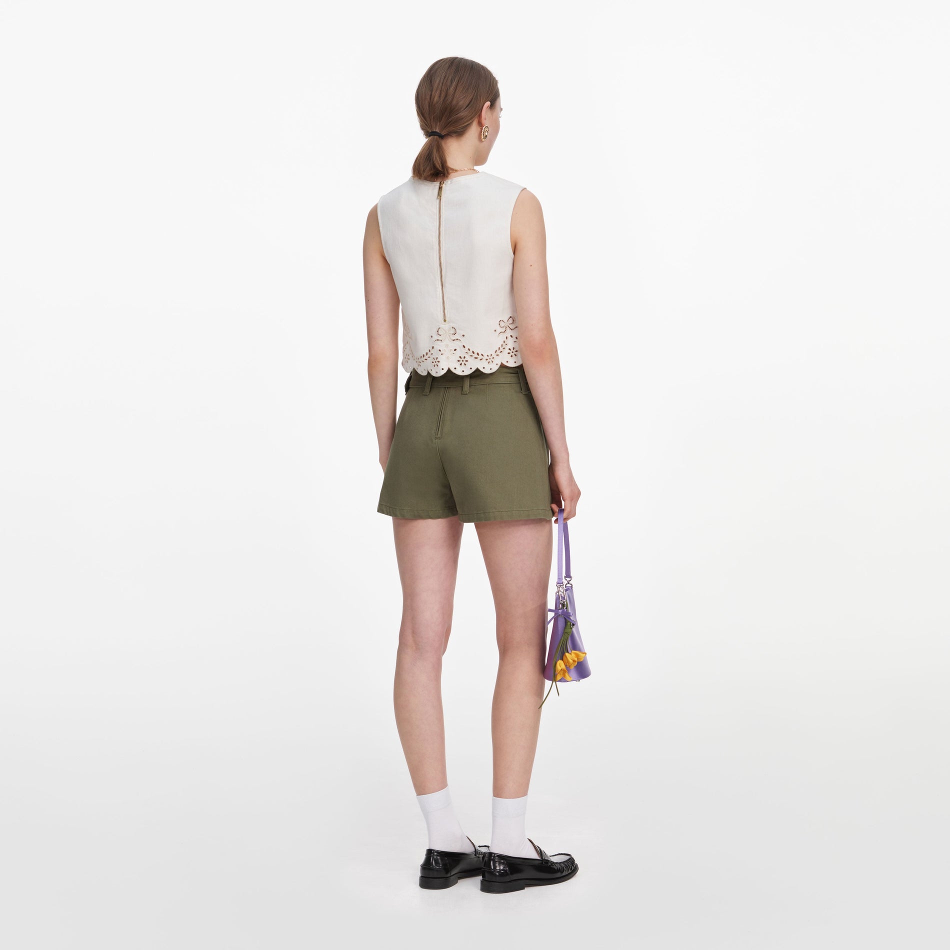 Back view of a woman wearing the Cream Broderie Denim Top