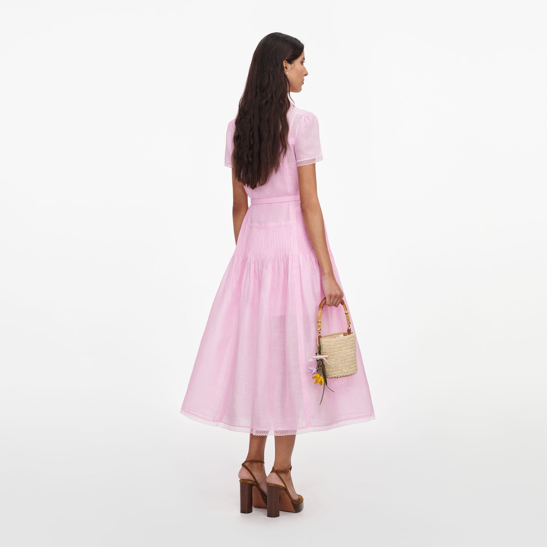 Back view of a woman wearing the Pink Embroidered Midi Dress