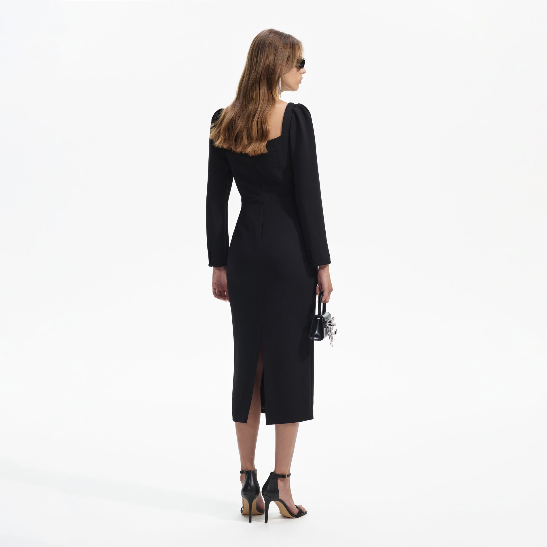 Back view of a woman wearing the Black Diamante Bow Midi Dress