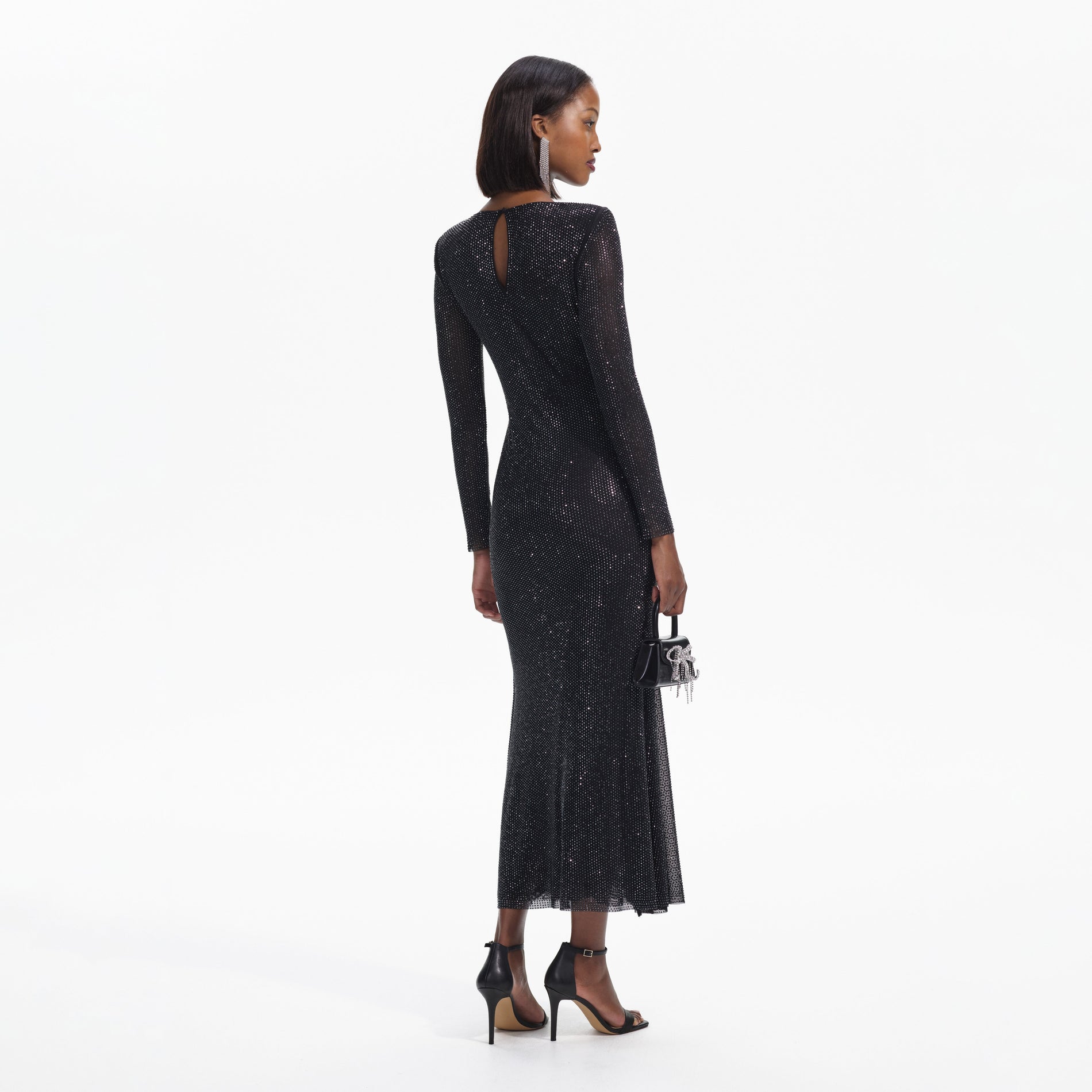 Back view of a woman wearing the Black Rhinestone Mesh V-Neck Midi Dress