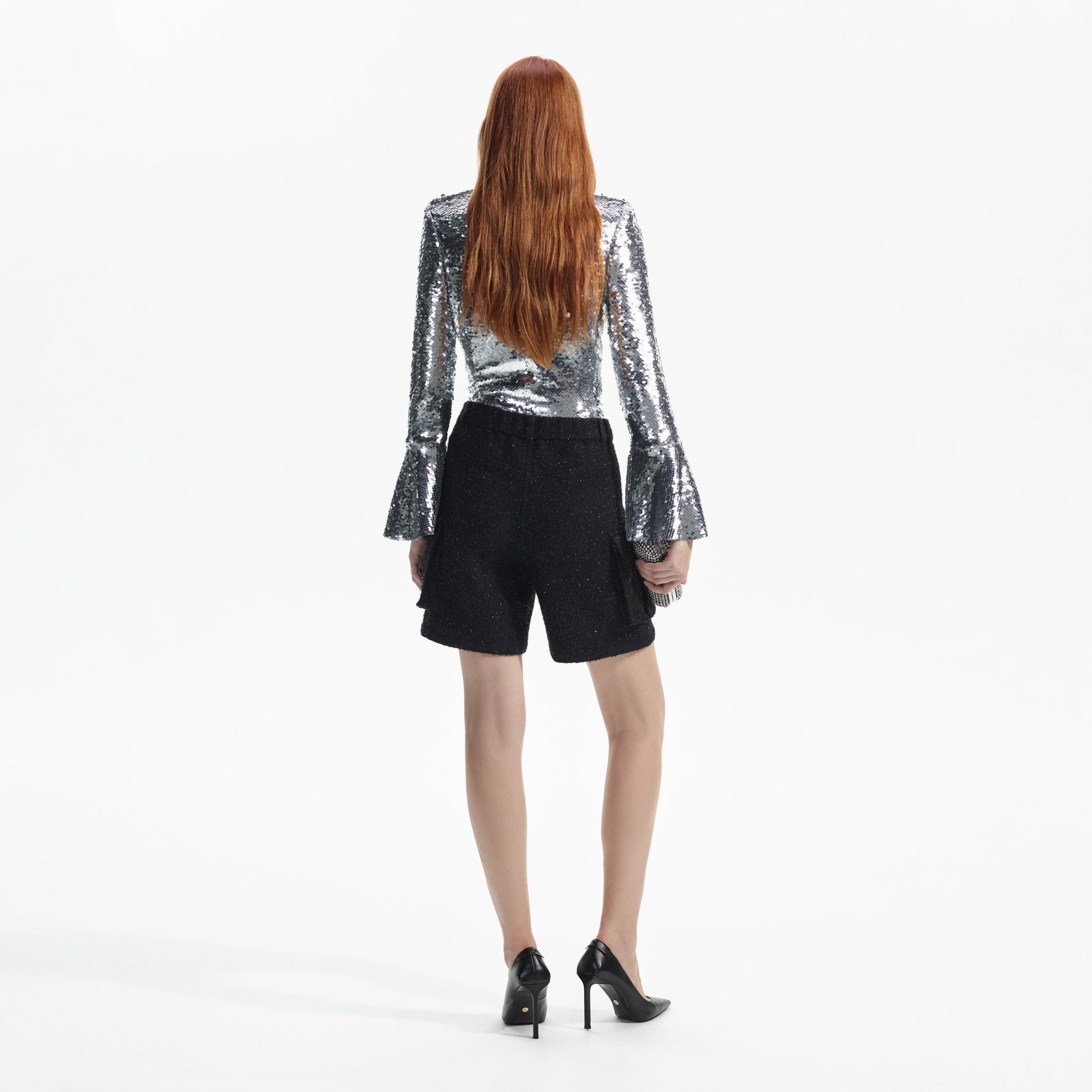 Back view of a woman wearing the Silver Sequin Flared Sleeve Top