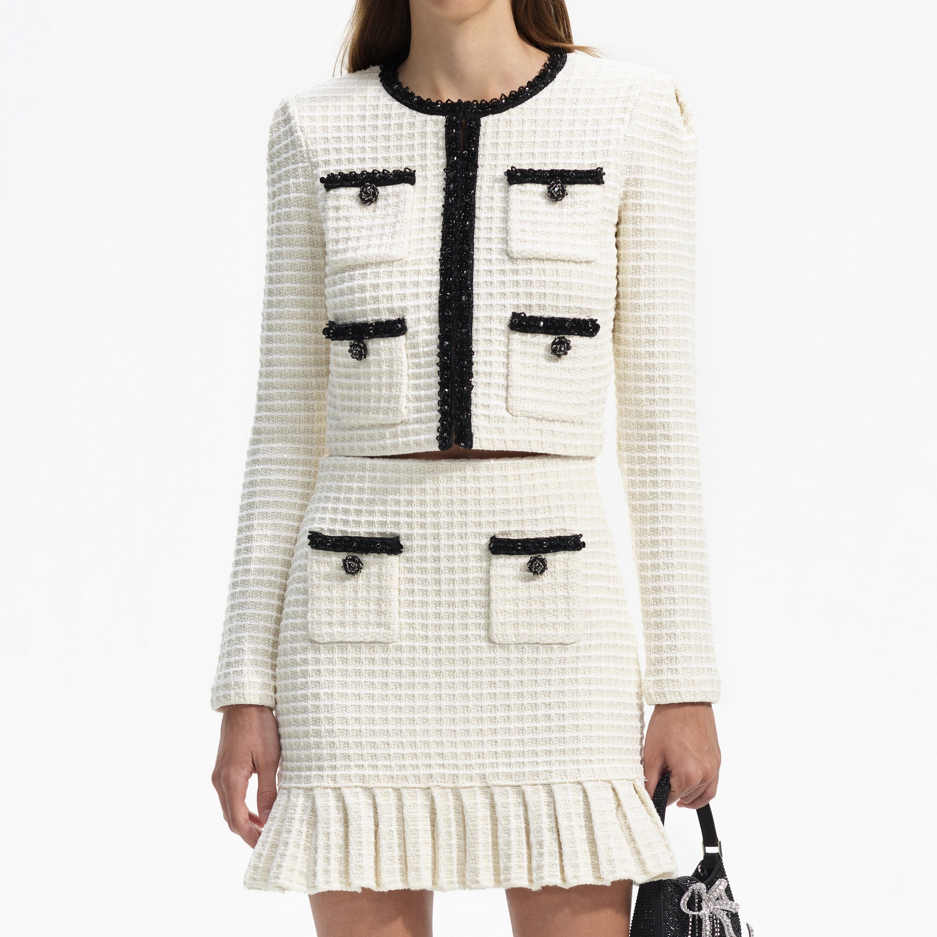 A close up of a woman wearing the Cream Textured Knit Mini Skirt