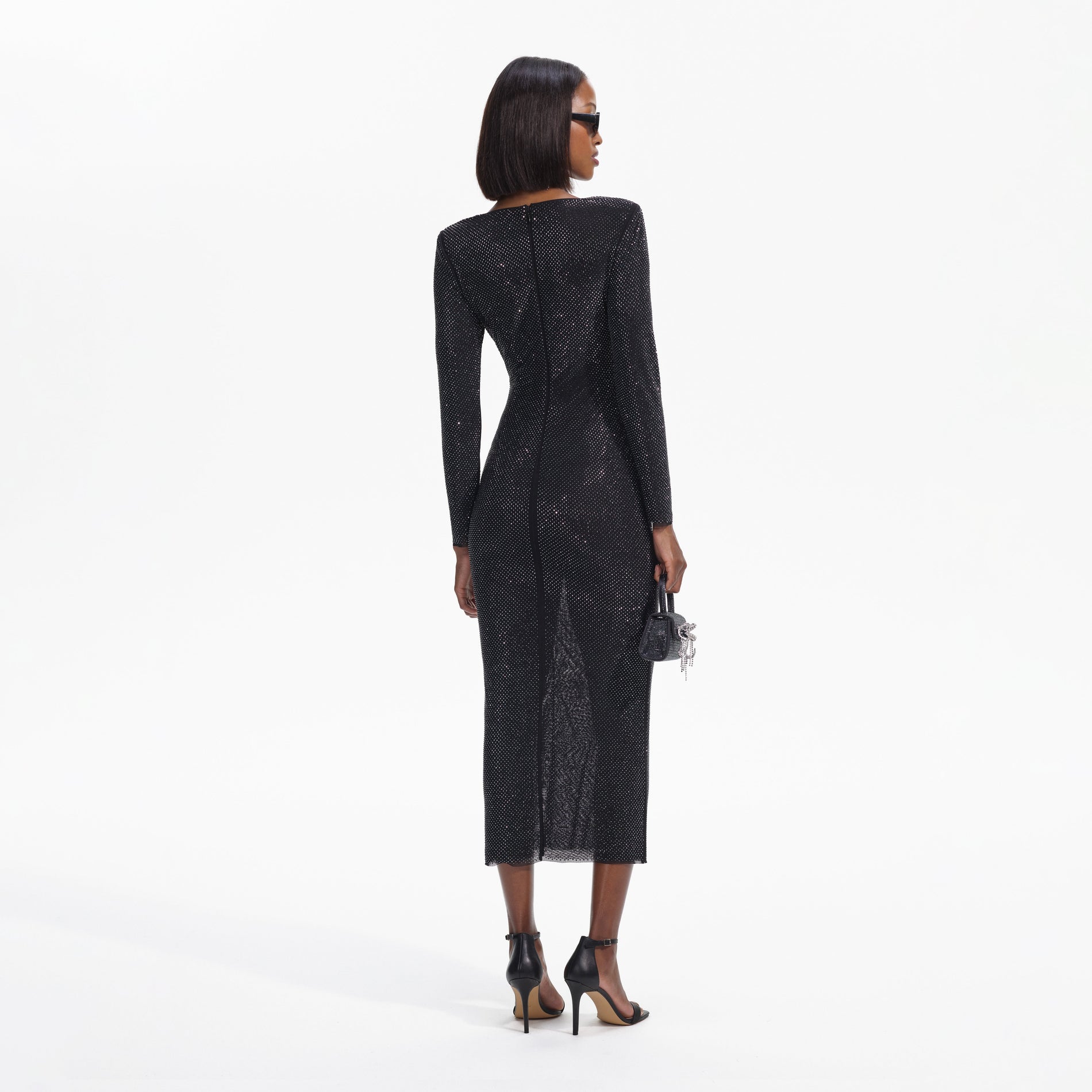 Back view of a woman wearing the Black Rhinestone Gathered Midi Dress