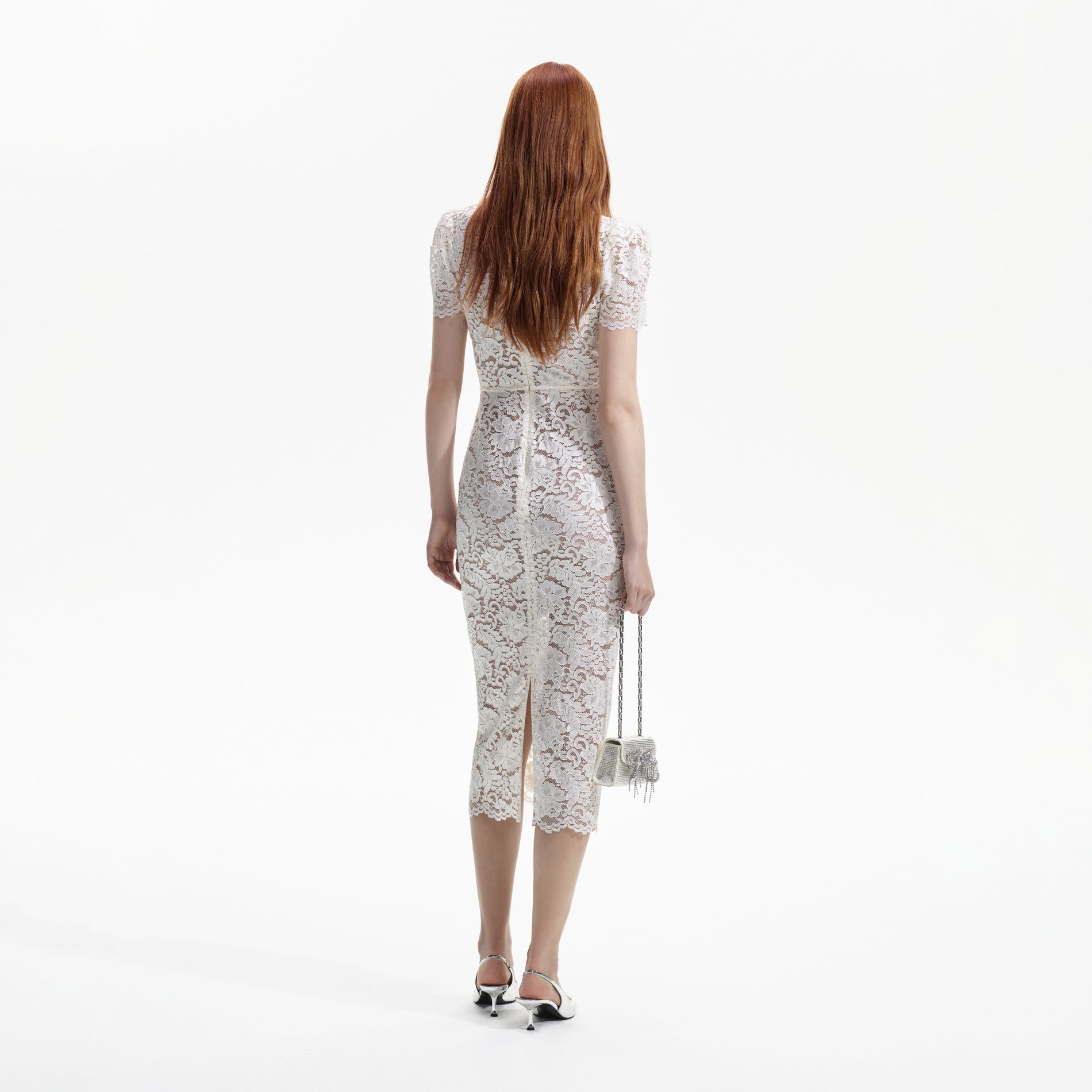 Back view of a woman wearing the Cream Cord Lace V-Neck Midi Dress