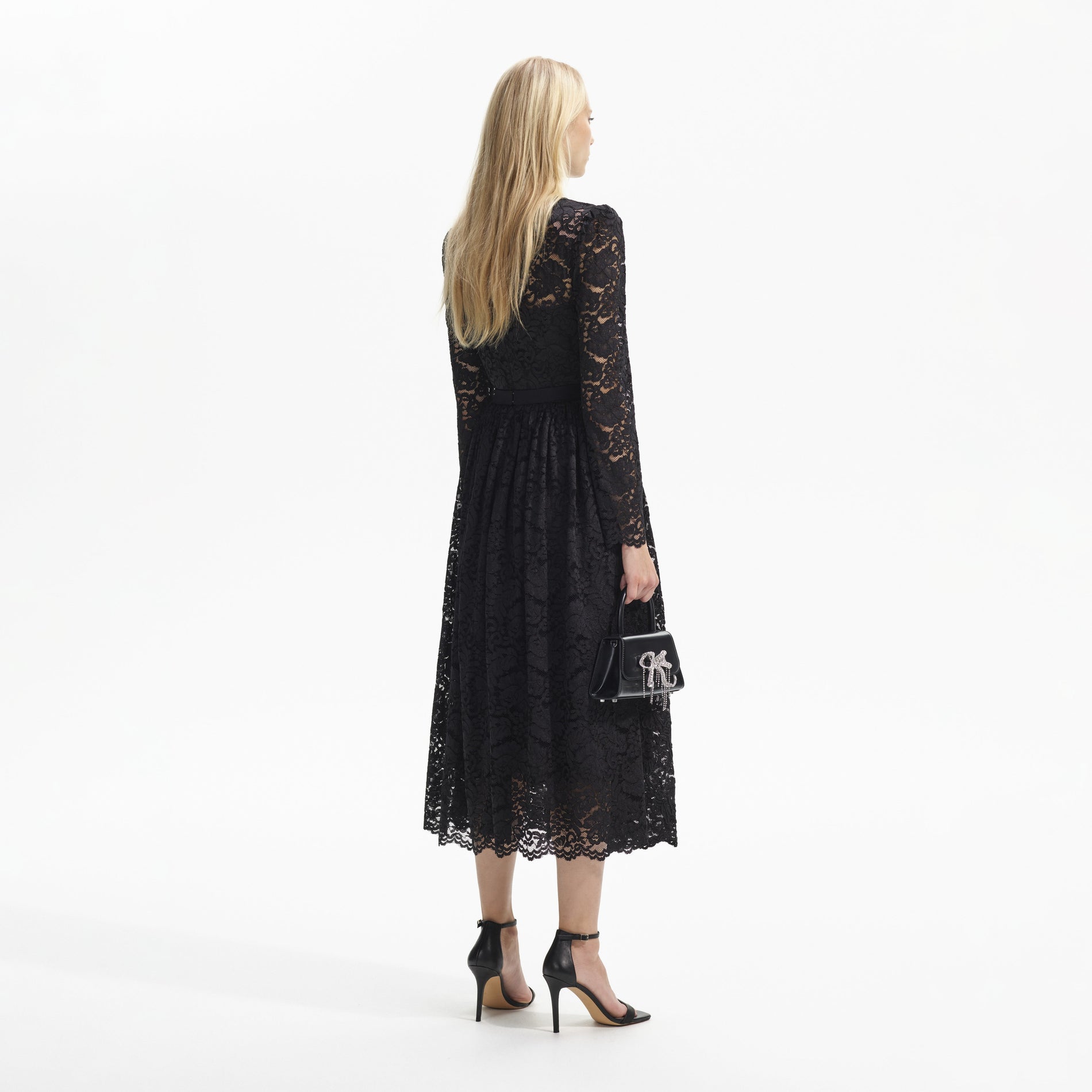 Back view of a woman wearing the Black Cord Lace Long Sleeve Midi Dress