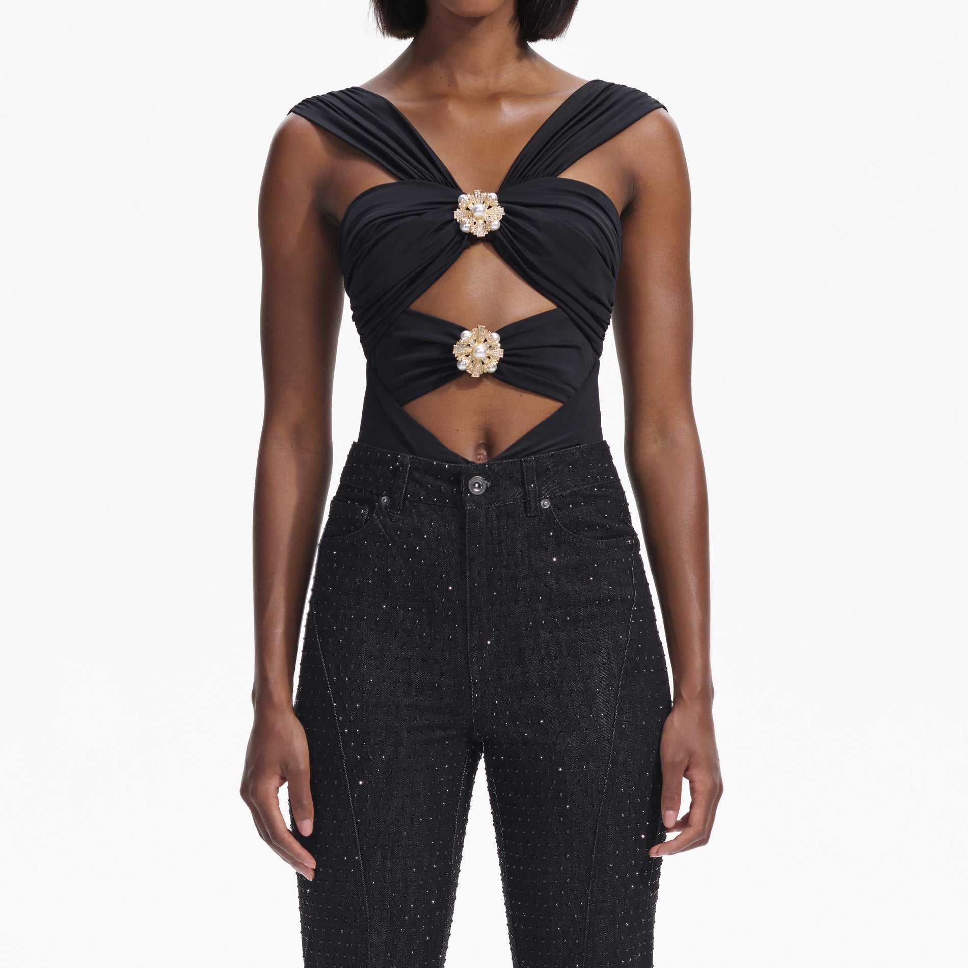 A close up of a woman wearing the Black Rhinestone Denim Jeans