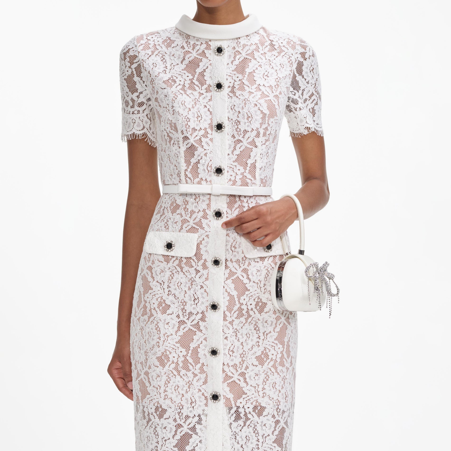 A close up of a woman wearing the White Lace Button Midi Dress