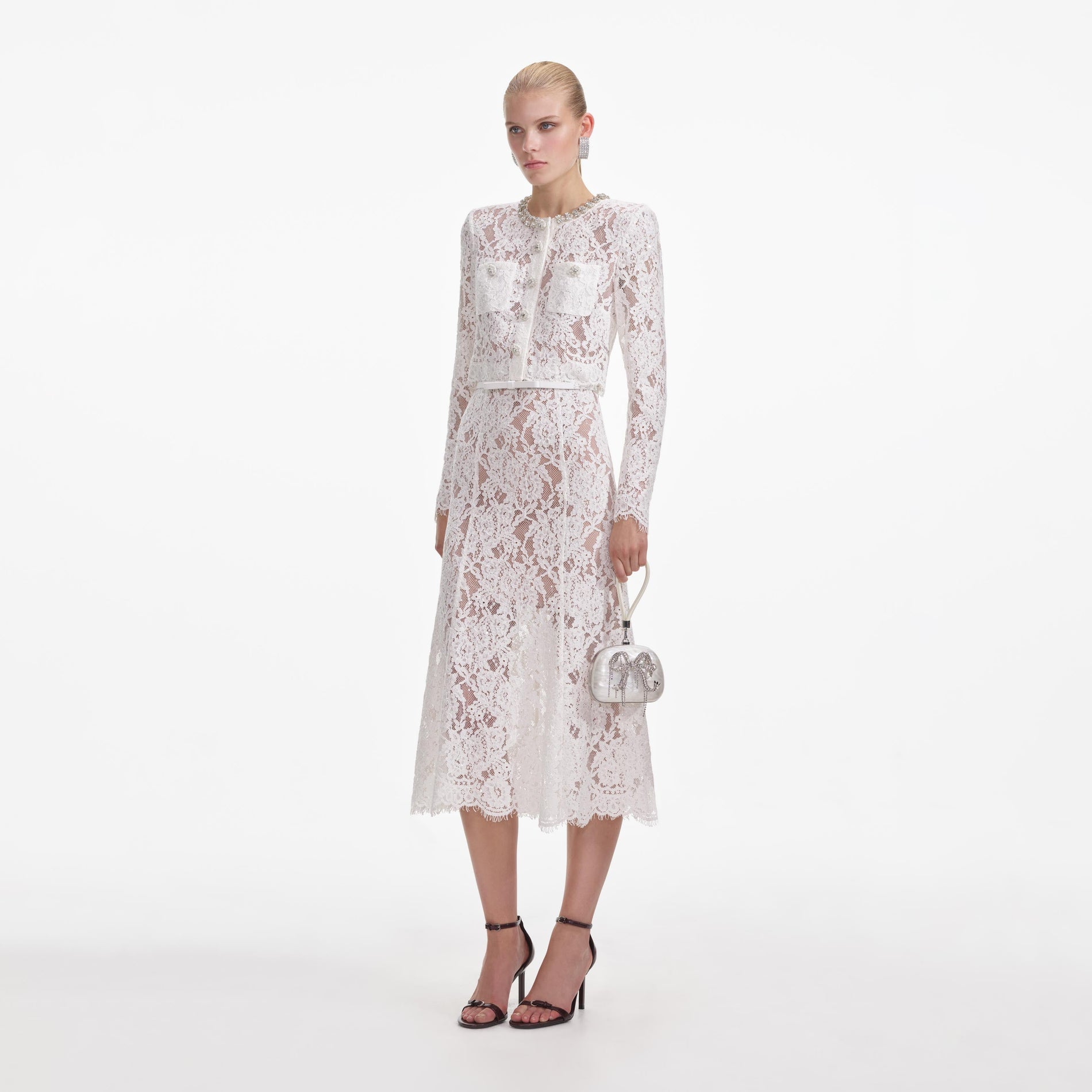 Side view of a woman wearing the White Lace Embellished Midi Dress